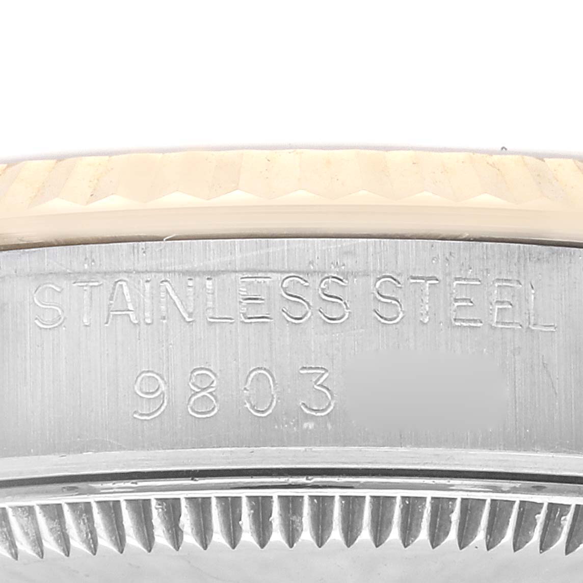 The image shows a close-up view of the edge of a Rolex Mid-Size 68273 Women's Steel and Gold (two tone) Champagne Dial 68273 Women's Steel and Gold (two tone) Champagne Dial watch case, displaying the stainless steel inscription and model number.