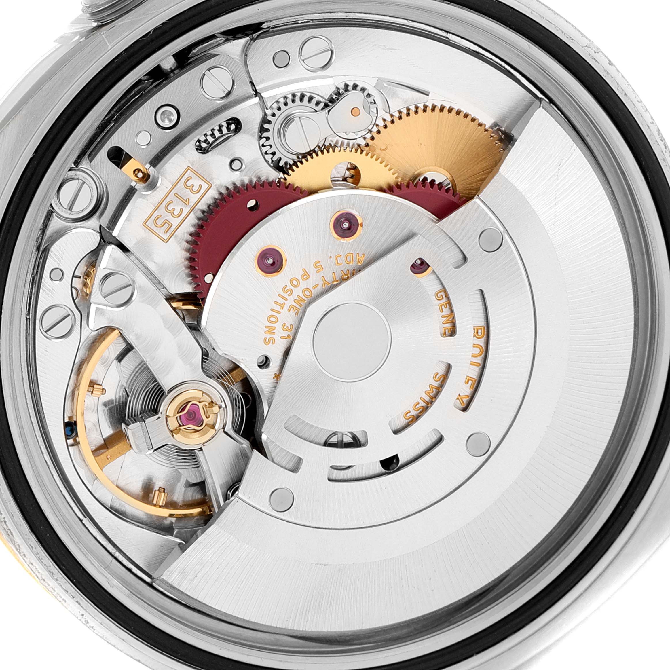 The image displays the inner mechanism of the Rolex Datejust 116233 Men's Steel and Gold (two tone) Silver Dial 116233 Men's Steel and Gold (two tone) Silver Dial watch, highlighting gears, screws, and the rotor.