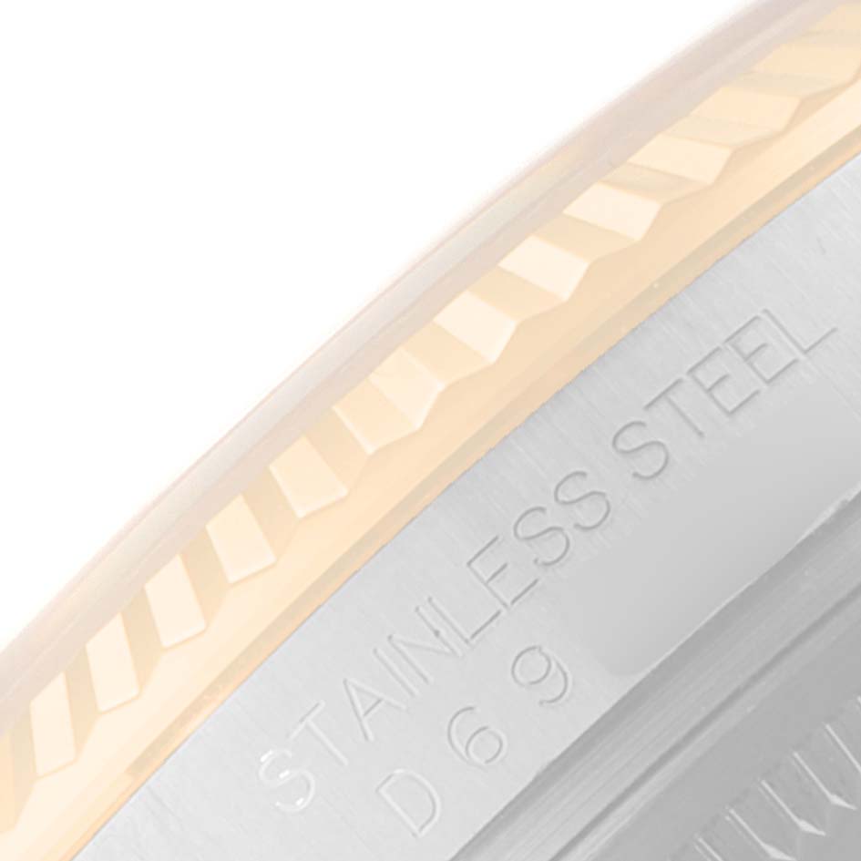 This image shows a close-up angle of the bezel and part of the case back of a Rolex Datejust 116233 Men's Steel and Gold (two tone) Silver Dial 116233 Men's Steel and Gold (two tone) Silver Dial model, highlighting the "STAINLESS STEEL" engraving.