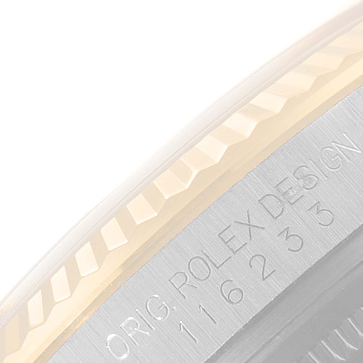 This close-up image shows the side engraving and part of the fluted bezel of a Rolex Datejust 116233 Men's Steel and Gold (two tone) White Dial 116233 Men's Steel and Gold (two tone) White Dial watch.