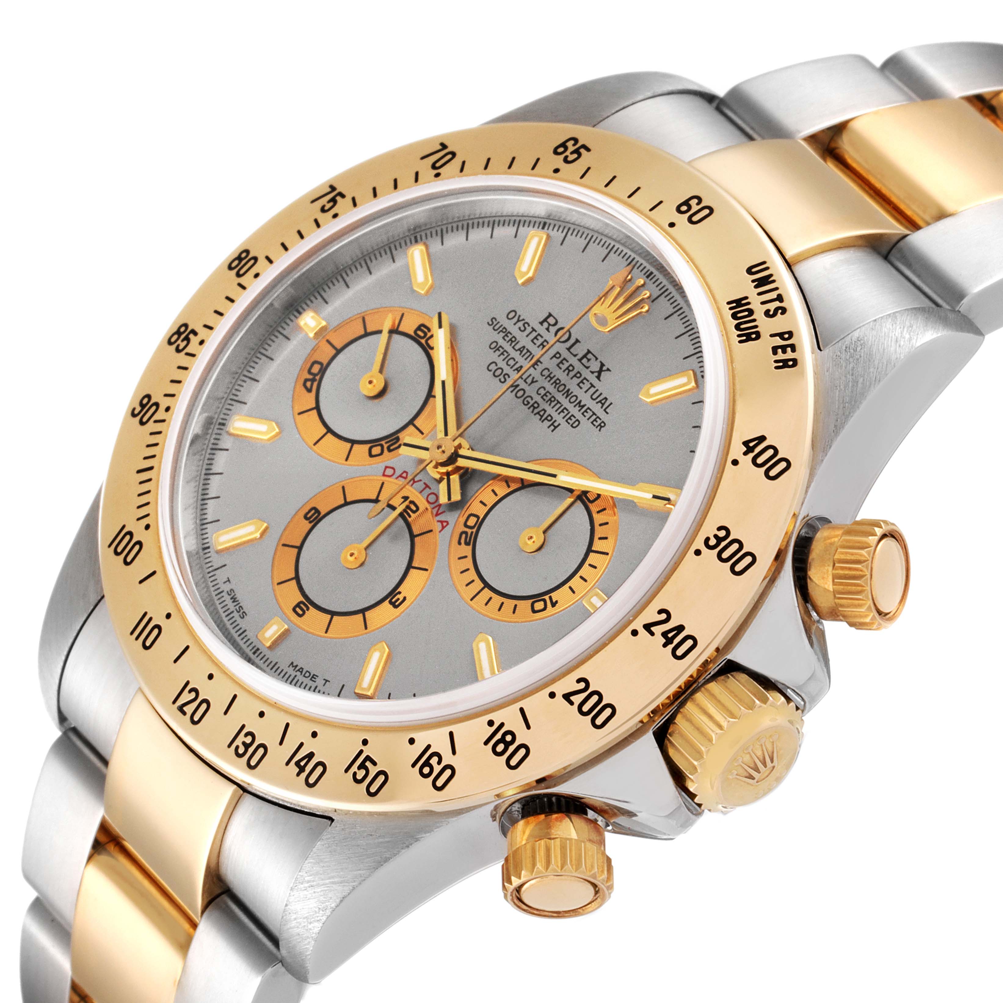 This Rolex Daytona 16523 Men
s Steel and Gold (two tone) Grey Dial 16523 Men
s Steel and Gold (two tone) Grey Dial watch is shown from an angled perspective, highlighting the face, bezel, crown, and part of the band.