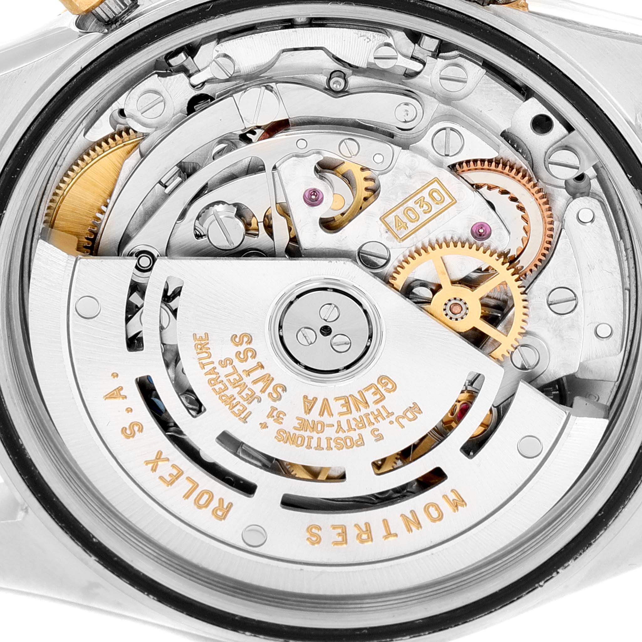 The image shows the movement and inner mechanical parts of a Rolex Daytona 16523 Men
s Steel and Gold (two tone) Grey Dial 16523 Men
s Steel and Gold (two tone) Grey Dial watch at a close-up angle.