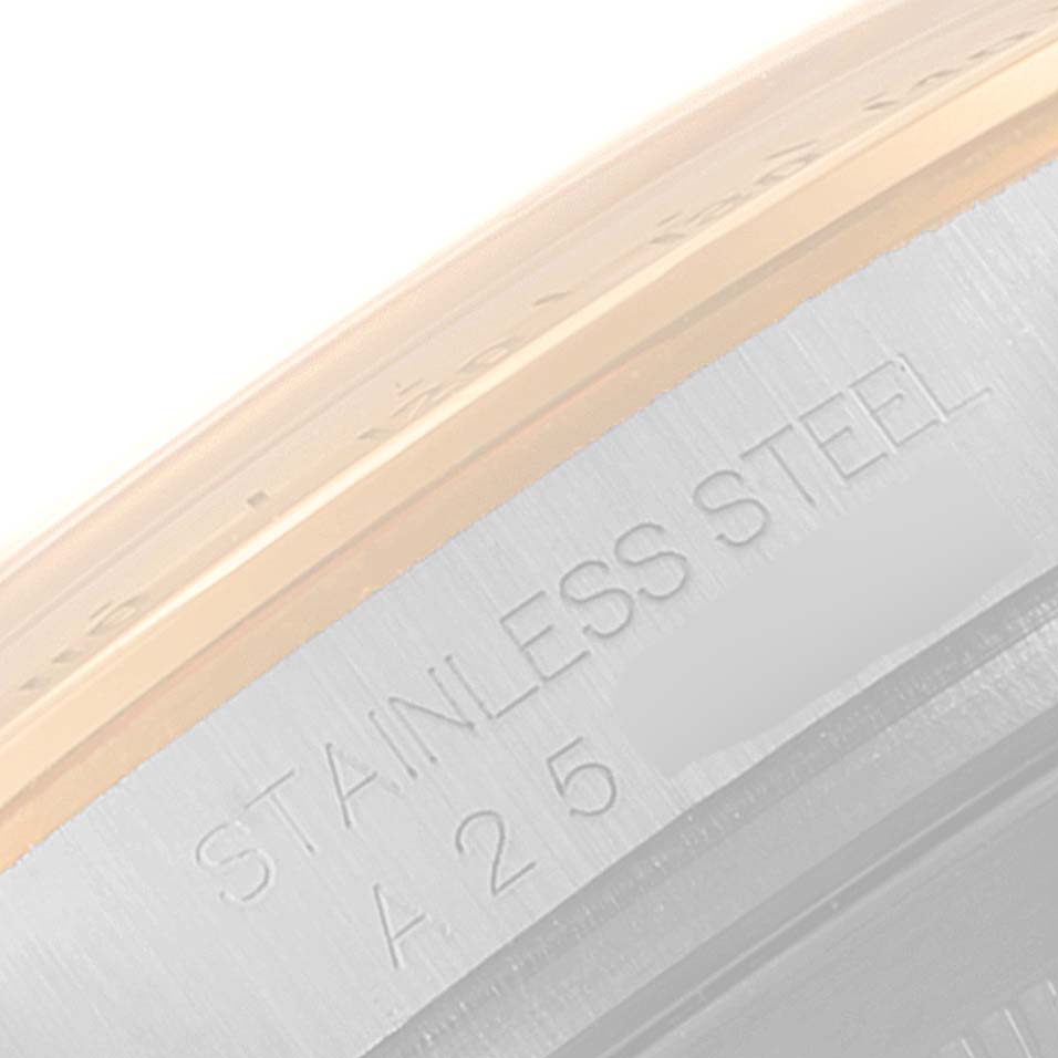 This is a close-up view of the case engraving on a Rolex Daytona 16523 Men
s Steel and Gold (two tone) Grey Dial 16523 Men
s Steel and Gold (two tone) Grey Dial watch, showing "STAINLESS STEEL" and a partial serial number.