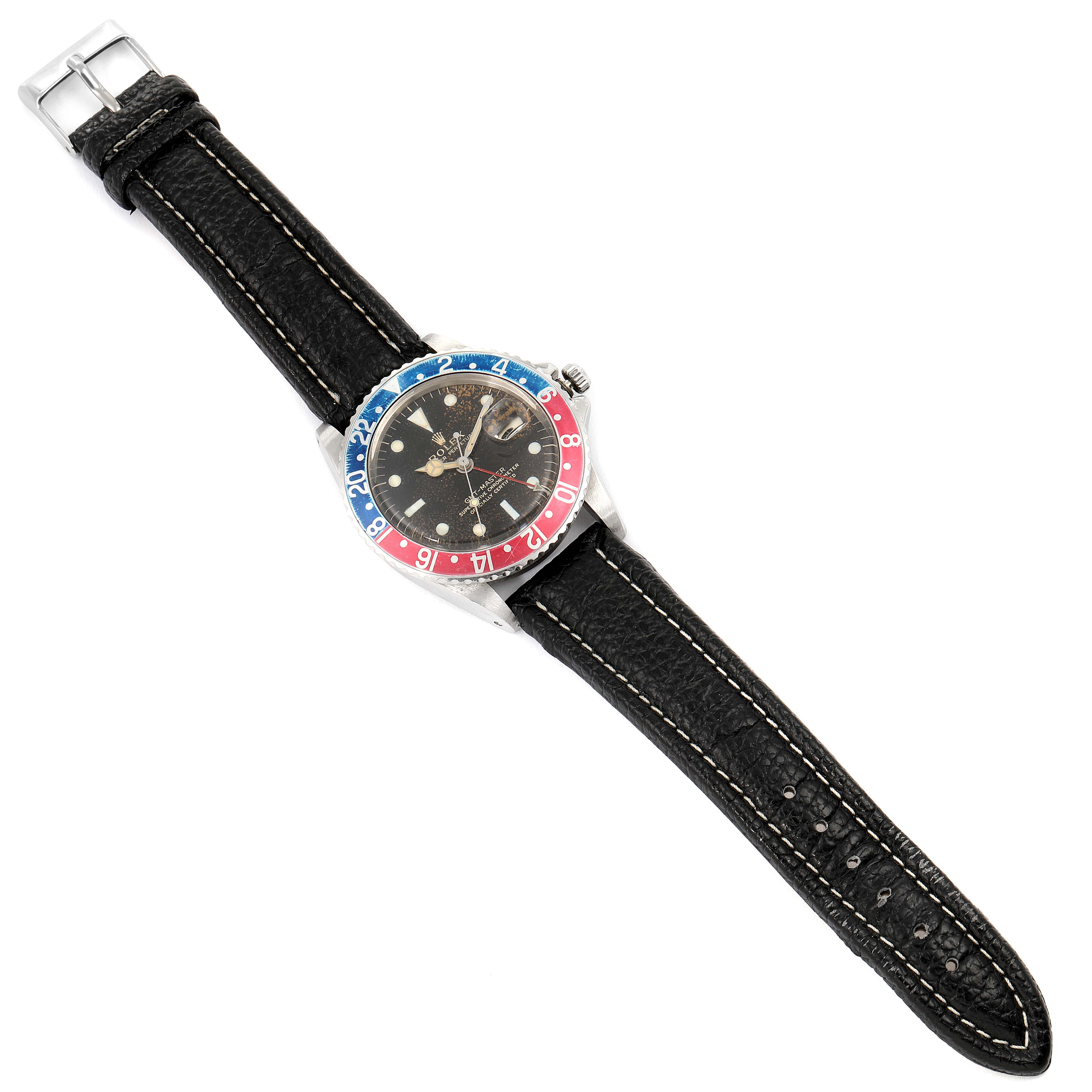 The Rolex Vintage Collection 1675 Men's Stainless Steel Black Dial 1675 Men's Stainless Steel Black Dial model watch is shown from a top view, displaying the dial, bezel, and leather strap.