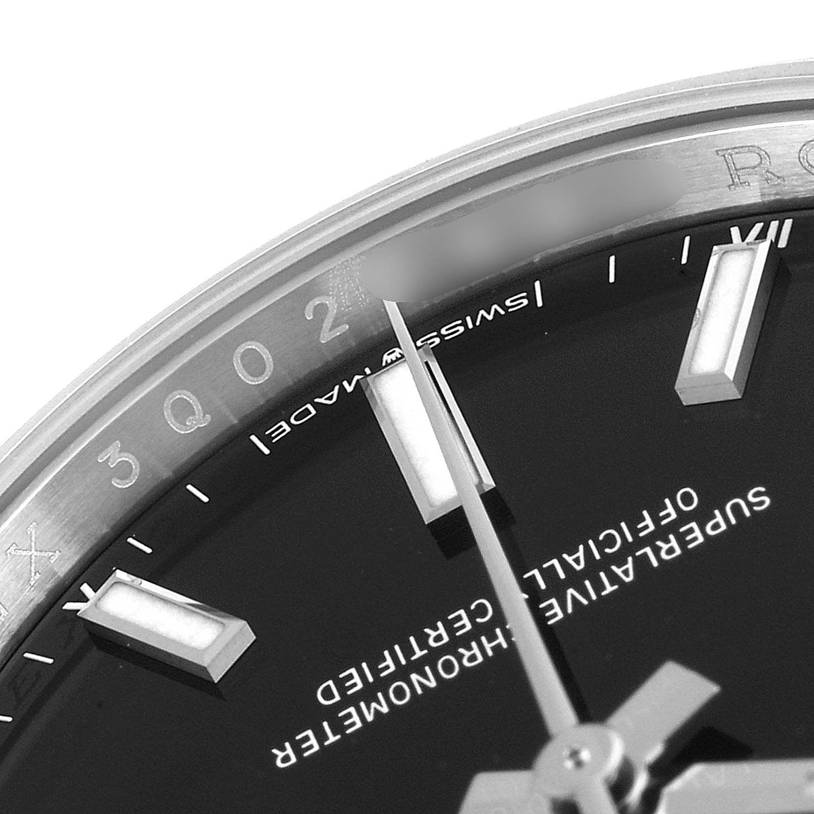 This image shows a close-up of the face and bezel of a Rolex Oyster Perpetual 124200 Men
s Stainless Steel Black Dial 124200 Men
s Stainless Steel Black Dial watch, focusing on the "SWISS MADE" text and indices.