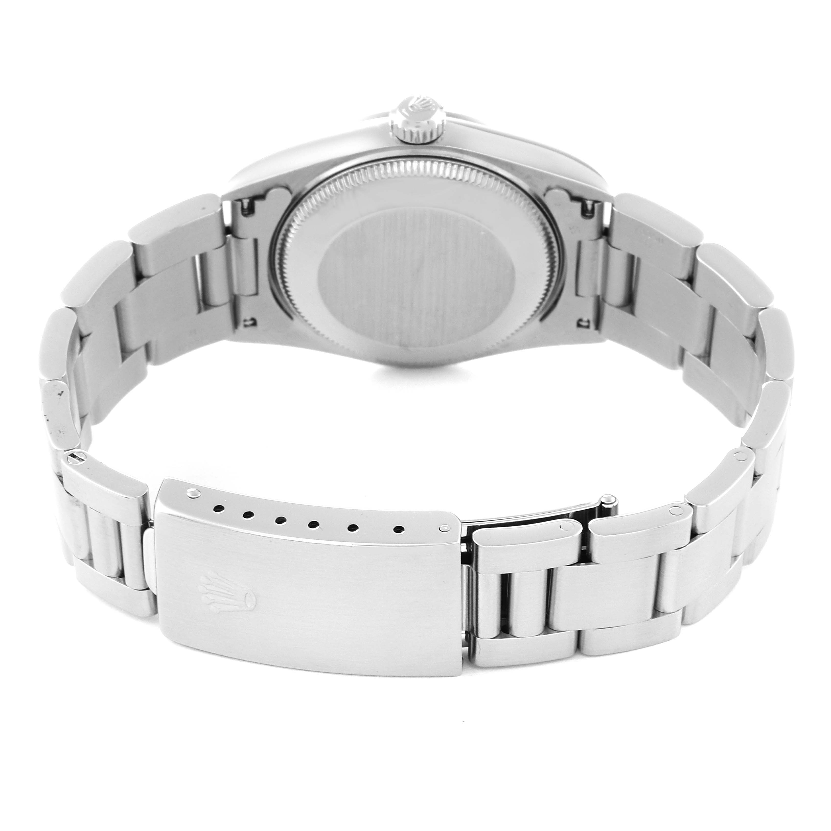 The image shows the back view of a Rolex Mid-Size 67480 Women
s Stainless Steel Silver Dial 67480 Women
s Stainless Steel Silver Dial watch, highlighting the case back and partially open metal bracelet.