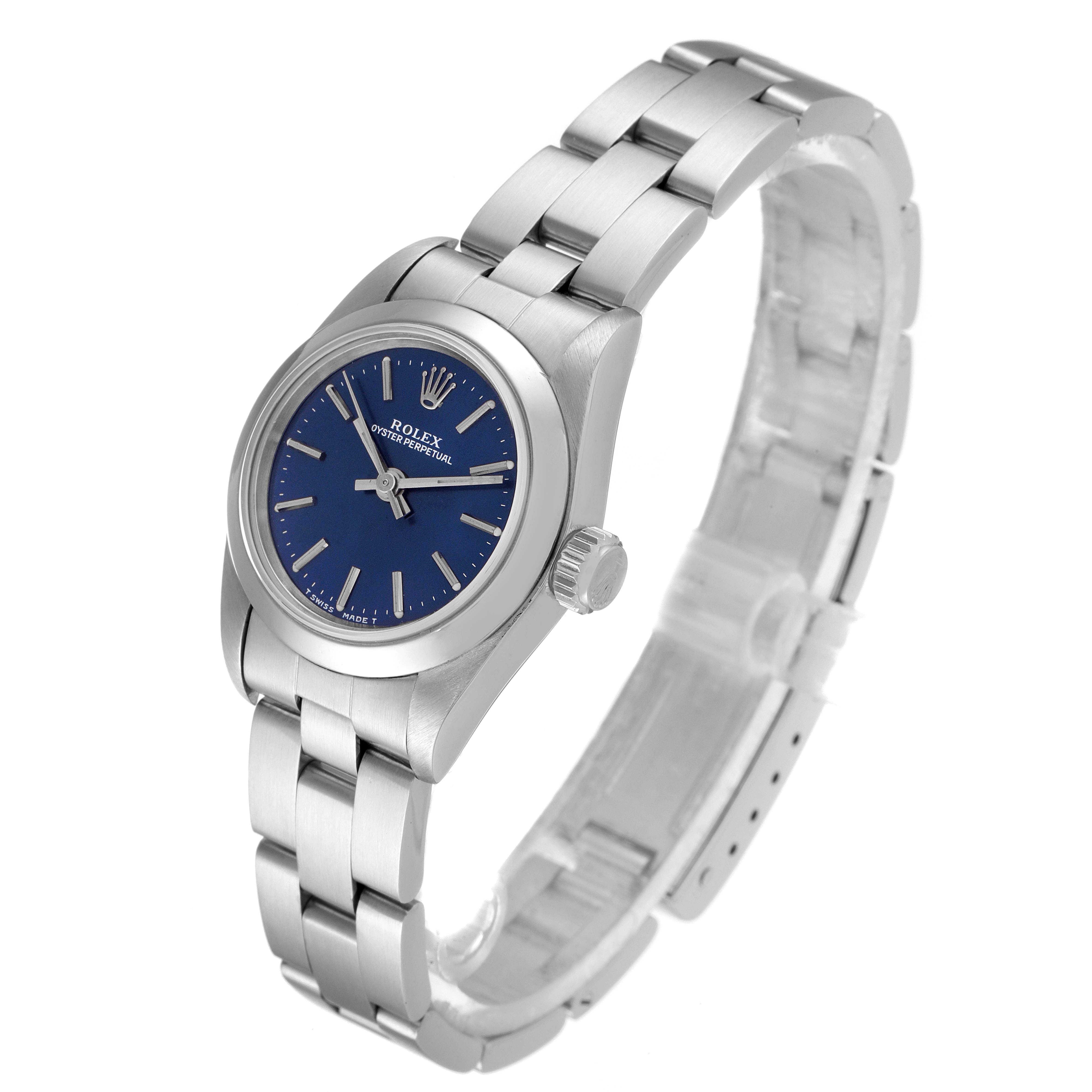 The Rolex Oyster Perpetual 67180 Women
s Stainless Steel Blue Dial 67180 Women
s Stainless Steel Blue Dial watch is shown at a slight angle displaying the dial, bezel, crown, and part of the bracelet.