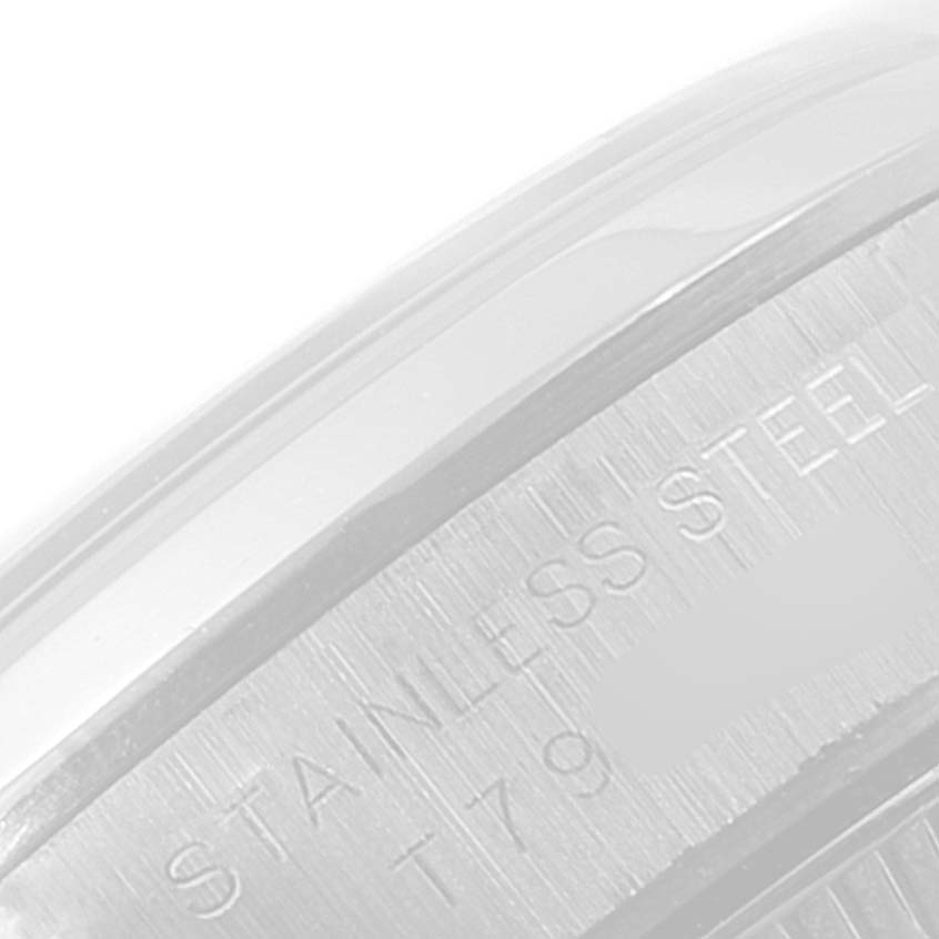 This close-up image of the Rolex Oyster Perpetual 67180 Women
s Stainless Steel Blue Dial 67180 Women
s Stainless Steel Blue Dial watch shows part of its stainless steel casing and engravings.