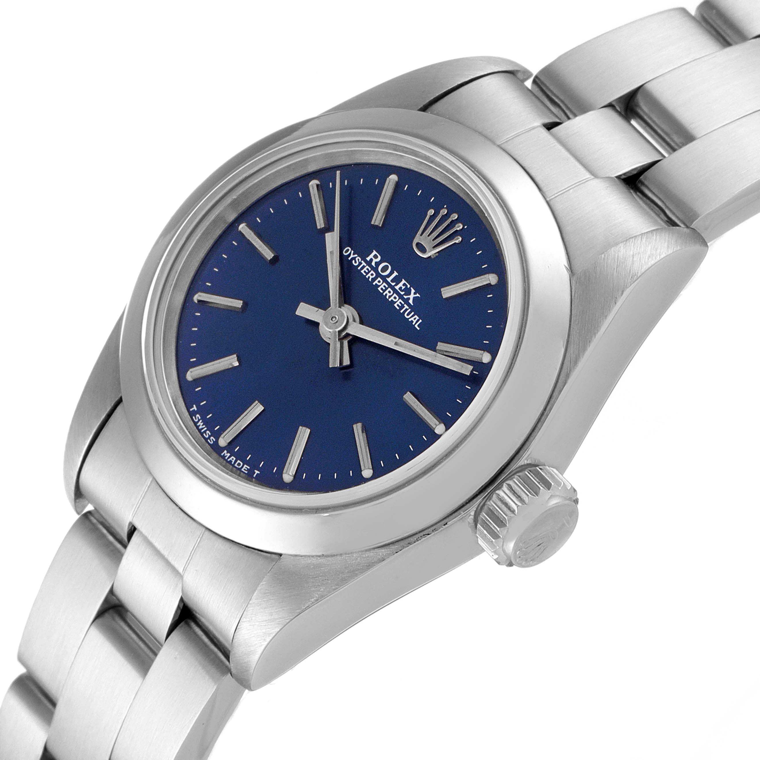 The Rolex Oyster Perpetual 67180 Women
s Stainless Steel Blue Dial 67180 Women
s Stainless Steel Blue Dial watch is shown at an angled view, highlighting its blue dial, crown, and stainless steel bracelet.