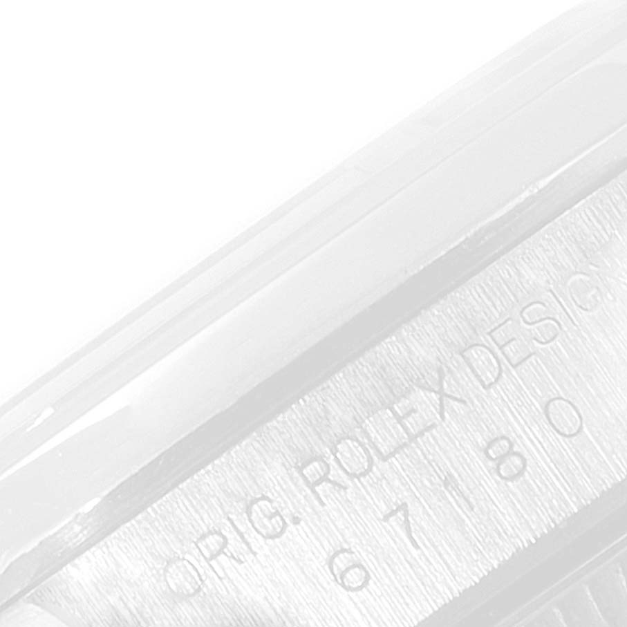 This image shows a close-up view of the engraved side of a Rolex Oyster Perpetual 67180 Women
s Stainless Steel Blue Dial 67180 Women
s Stainless Steel Blue Dial watch.