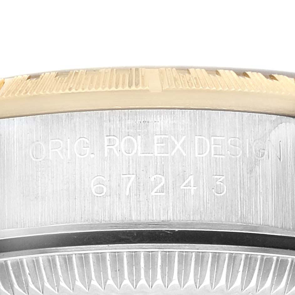 This image shows a close-up side view of the case of a Rolex Oyster Perpetual 67243 Women's Steel and Gold (two tone) Champagne Dial 67243 Women's Steel and Gold (two tone) Champagne Dial watch, highlighting the model number.