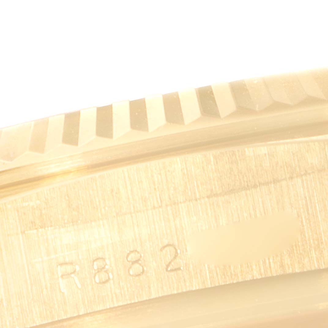 This close-up image features the fluted bezel and part of the engraved serial number of a Rolex President 18038 Men's Yellow Gold Champagne Dial 18038 Men's Yellow Gold Champagne Dial model watch.