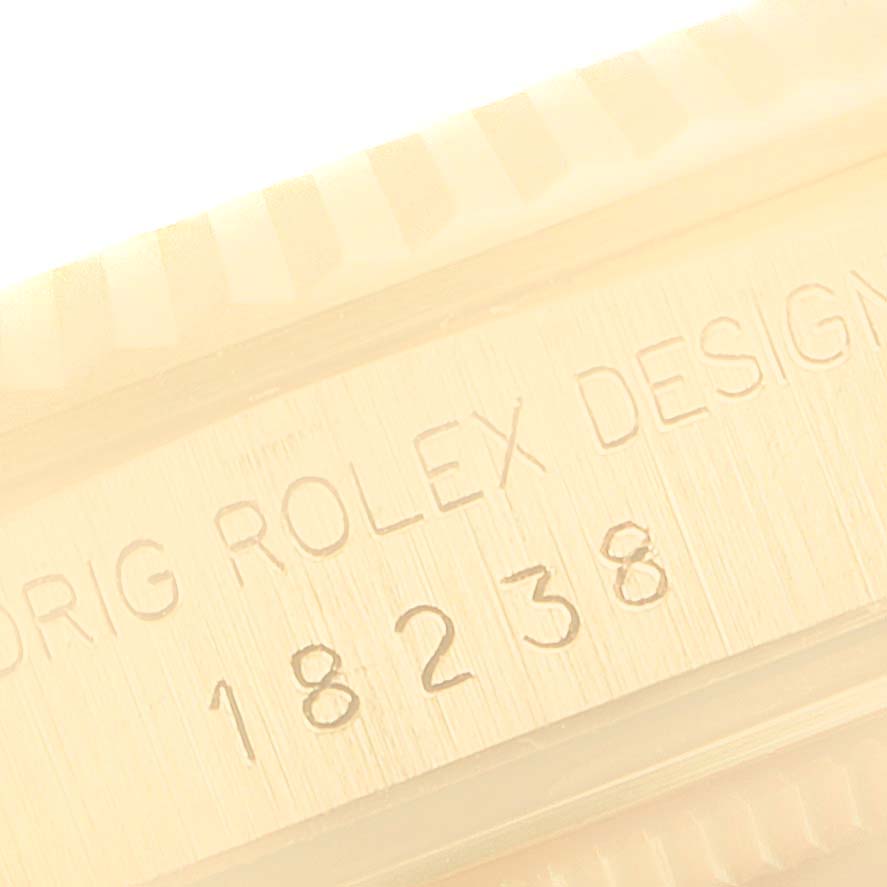 The close-up image shows the engraved serial number on the case of a Rolex President 18238 Men
s Yellow Gold White Dial 18238 Men
s Yellow Gold White Dial model watch.