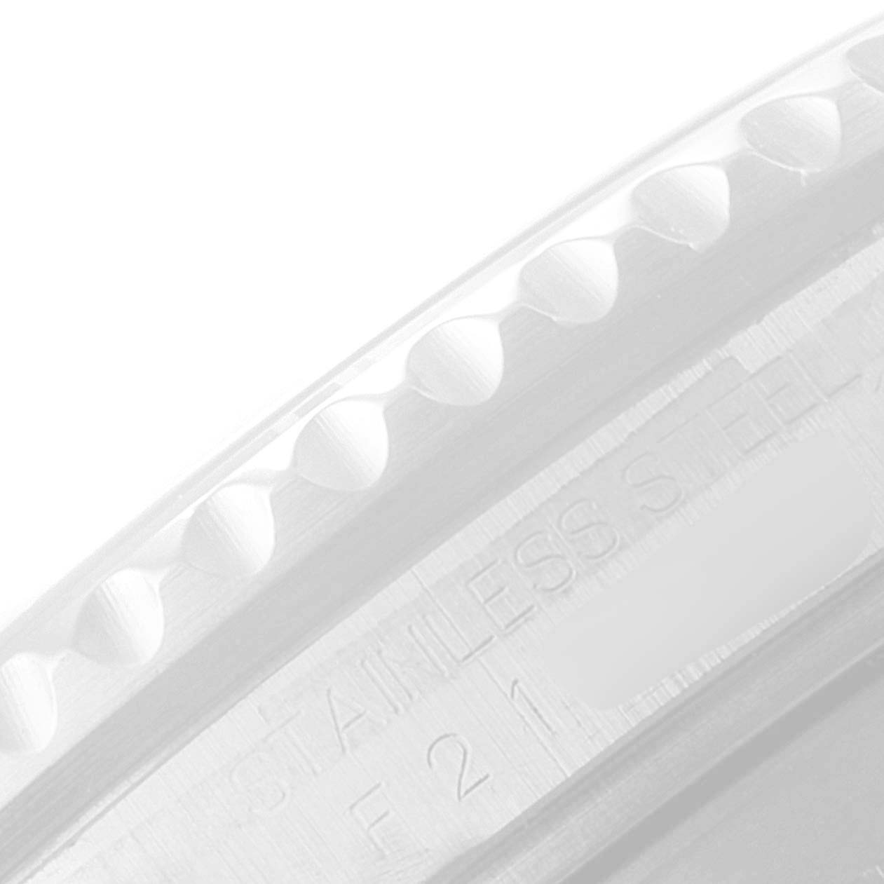 This image shows a close-up of the stainless steel edge of the bezel on a Rolex Submariner 16610LV Men's Stainless Steel Black Dial.