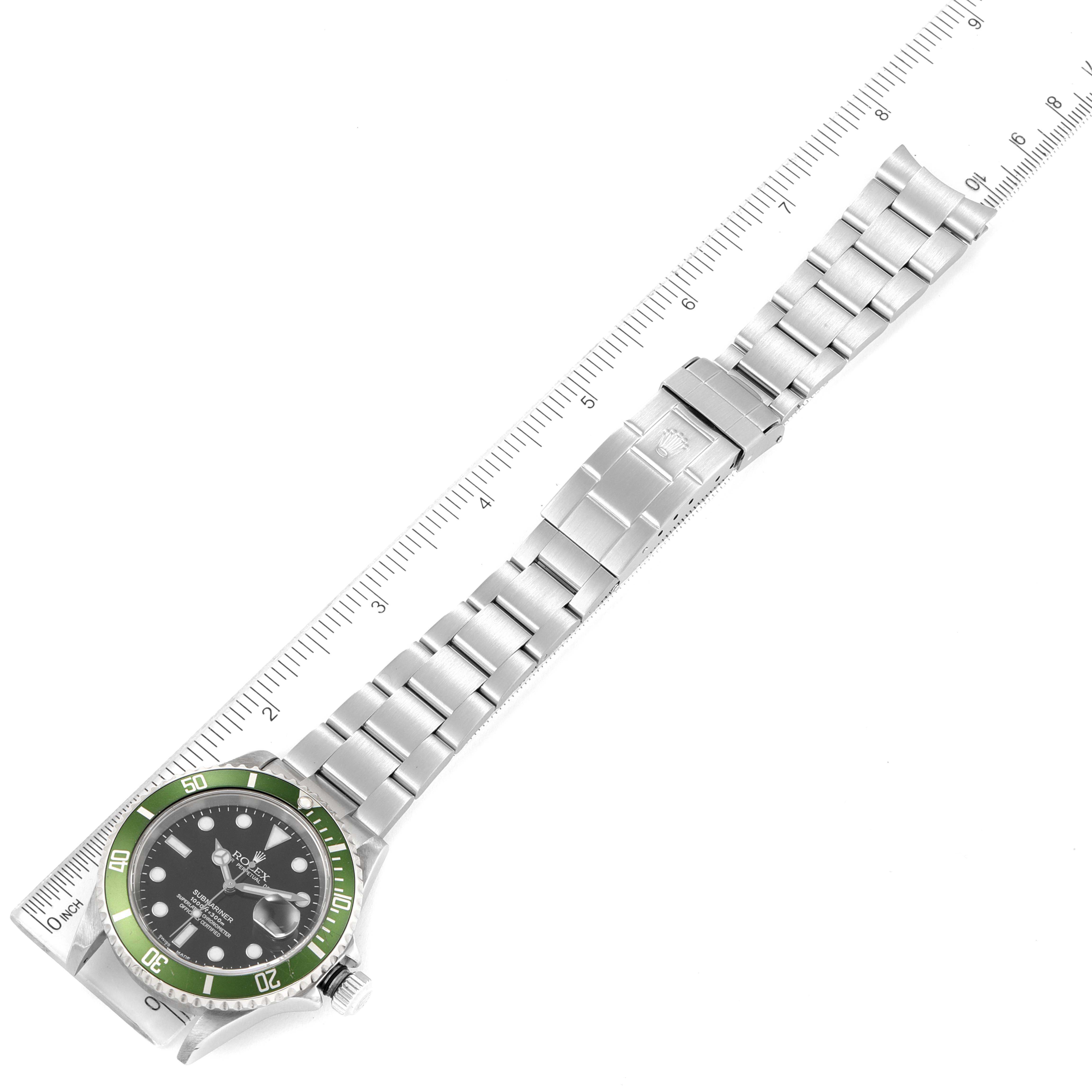 The Rolex Submariner 16610LV Men's Stainless Steel Black Dial watch is shown flat with its face, bracelet, and clasp visible alongside a ruler for scale.