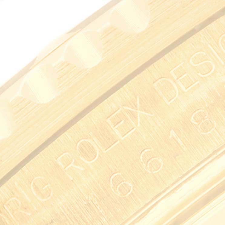 This image shows a close-up of the engraved side of a Rolex Submariner 16618 Men's Yellow Gold Blue Dial 16618 Men's Yellow Gold Blue Dial watch with part of the model number visible.