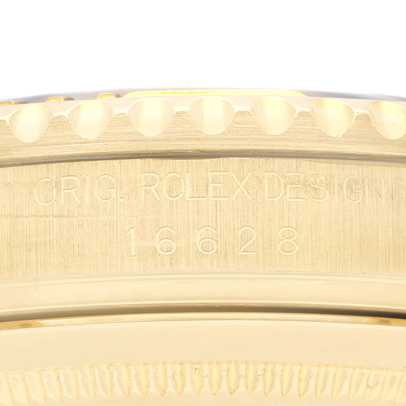 This image shows an up-close view of the engraved bezel and case back of a Rolex Yacht-Master 16628NGS Men's Yellow Gold Mother of Pearl Dial 16628NGS Men's Yellow Gold Mother of Pearl Dial model.