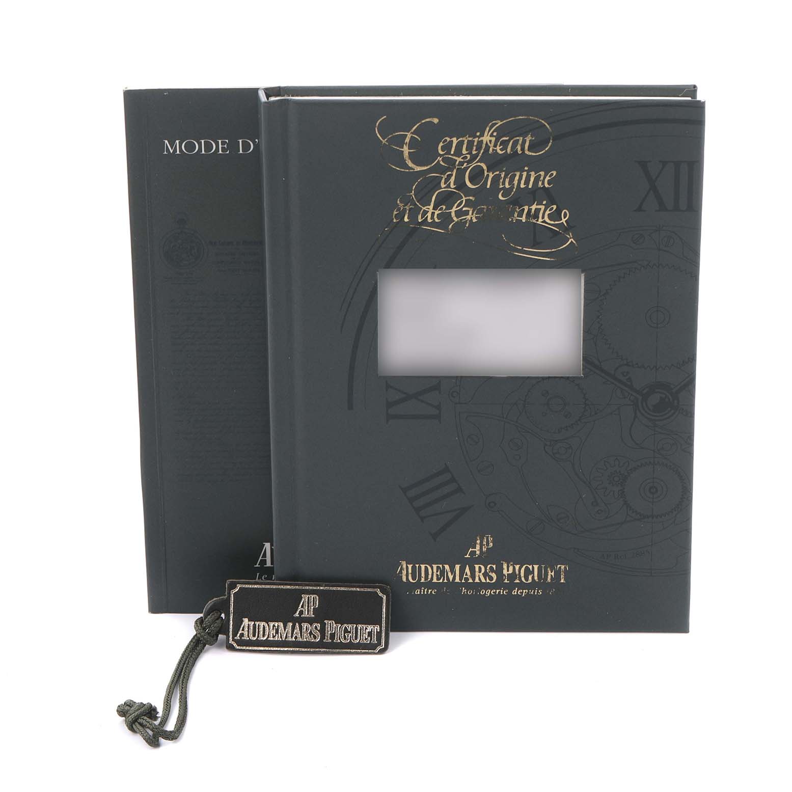 The image shows the documentation and tag for an Audemars Piguet Royal Oak 25730BA.OO.0789BA.06 Men's Yellow Gold Silver Dial 25730BA.OO.0789BA.06 Men's Yellow Gold Silver Dial watch, including a certificate booklet and branded tag.