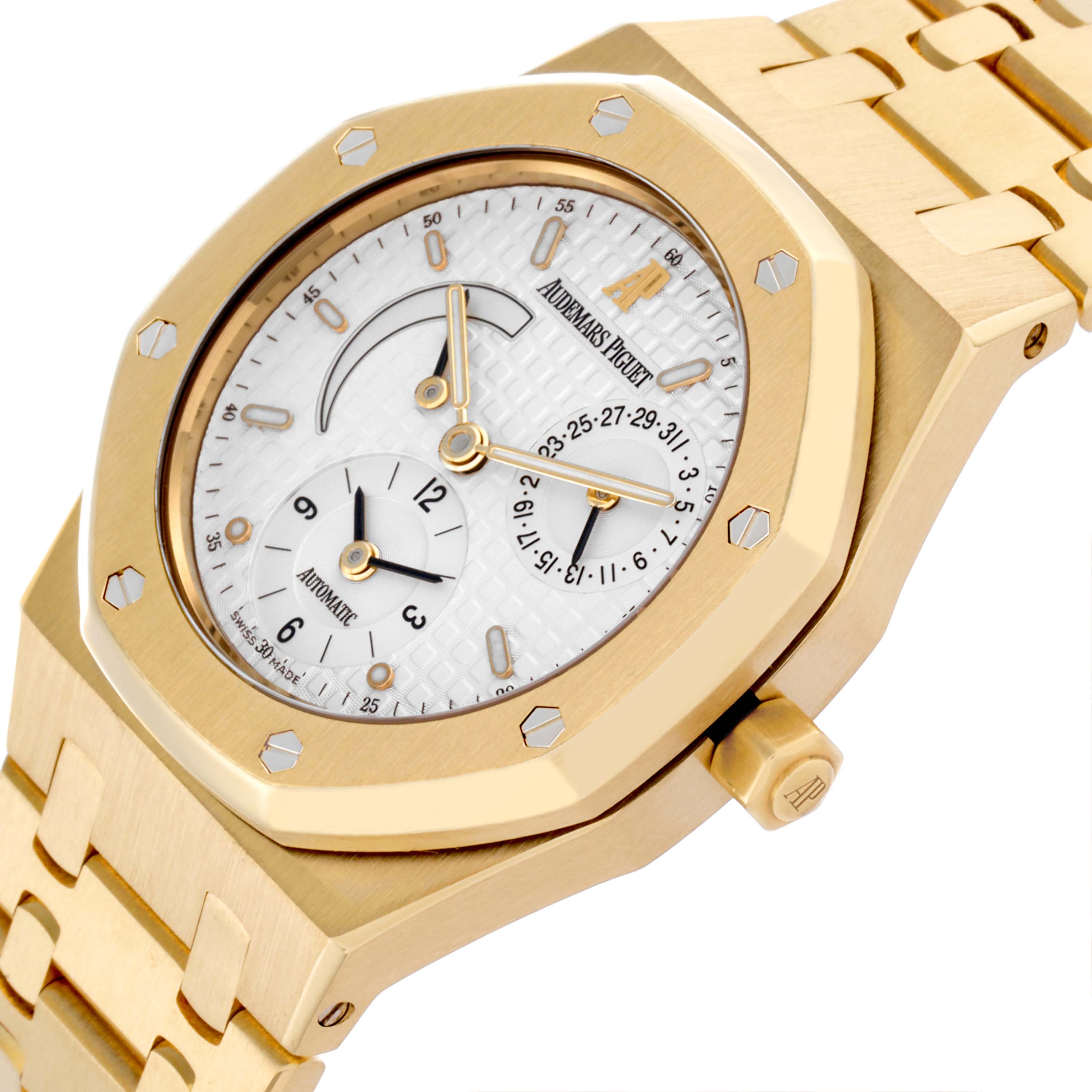 The image shows a side angle of the Audemars Piguet Royal Oak 25730BA.OO.0789BA.06 Men's Yellow Gold Silver Dial 25730BA.OO.0789BA.06 Men's Yellow Gold Silver Dial watch, highlighting the octagonal bezel, crown, and bracelet.