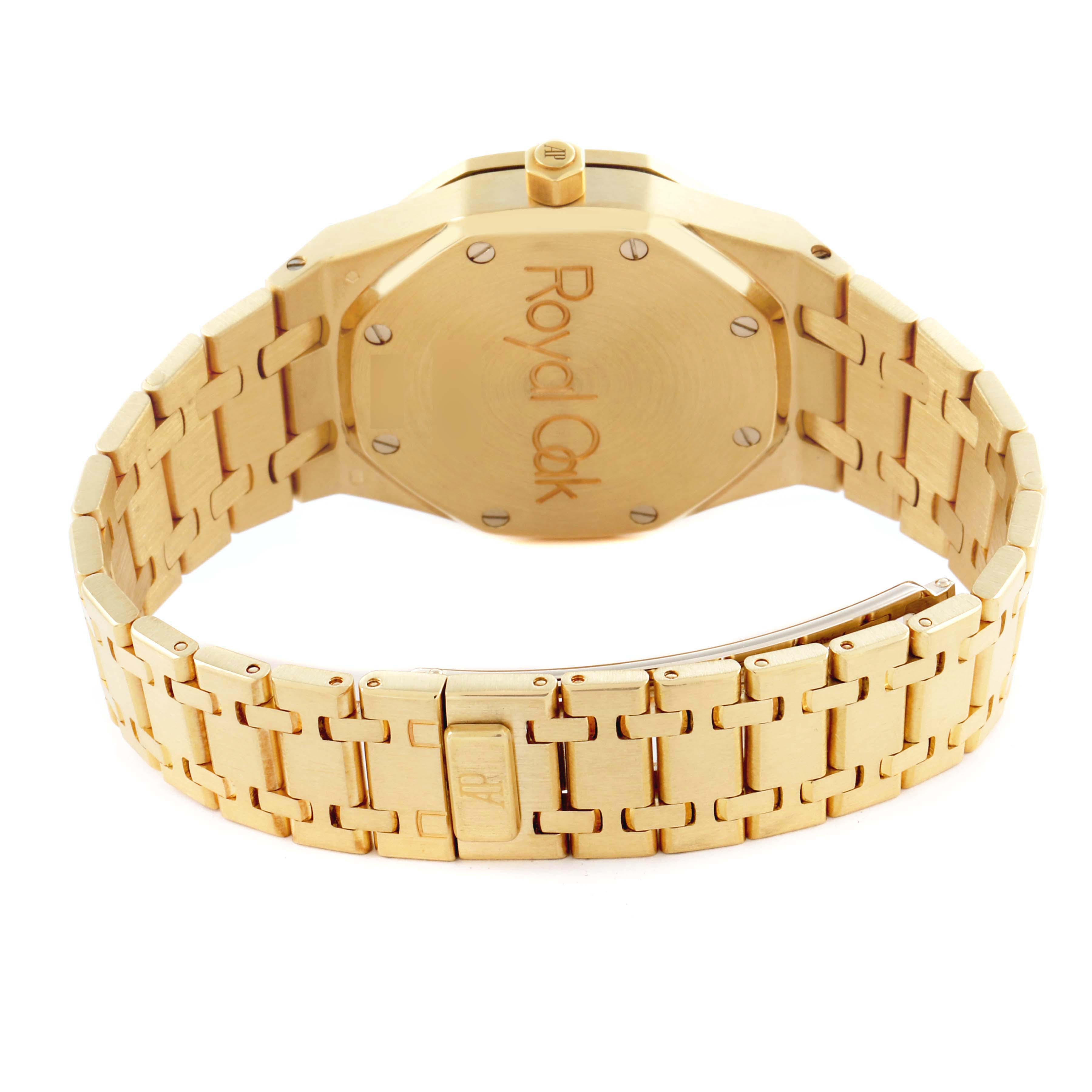 The image shows the back of an Audemars Piguet Royal Oak 25730BA.OO.0789BA.06 Men's Yellow Gold Silver Dial 25730BA.OO.0789BA.06 Men's Yellow Gold Silver Dial watch, highlighting the case back and bracelet with the clasp open.