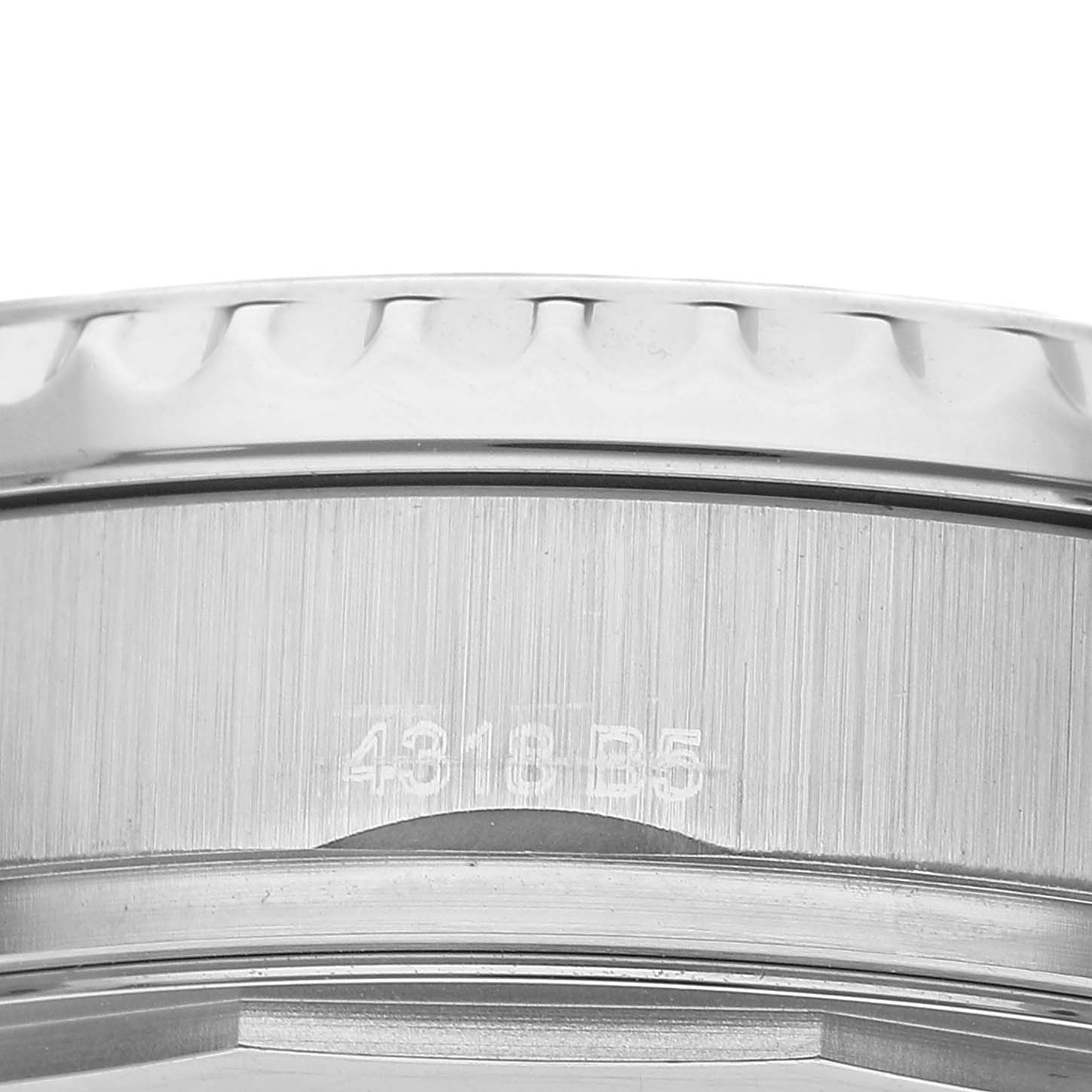 The image shows a close-up of the bezel and part of the case of a Breitling Aviator AB3521U41B1A1 Men's Stainless Steel Blue Dial watch.