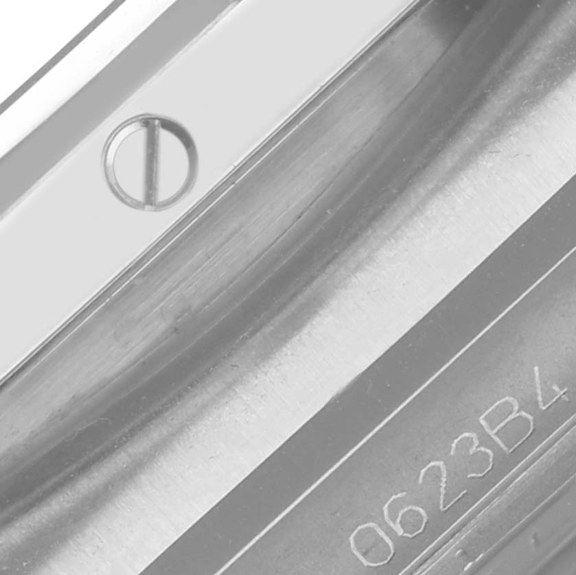 The image shows a close-up of the screw and engraved edge on a Breitling Chronomat AB0136251B1A2 Men's Stainless Steel Black Dial AB0136251B1A2 Men's Stainless Steel Black Dial watch case.