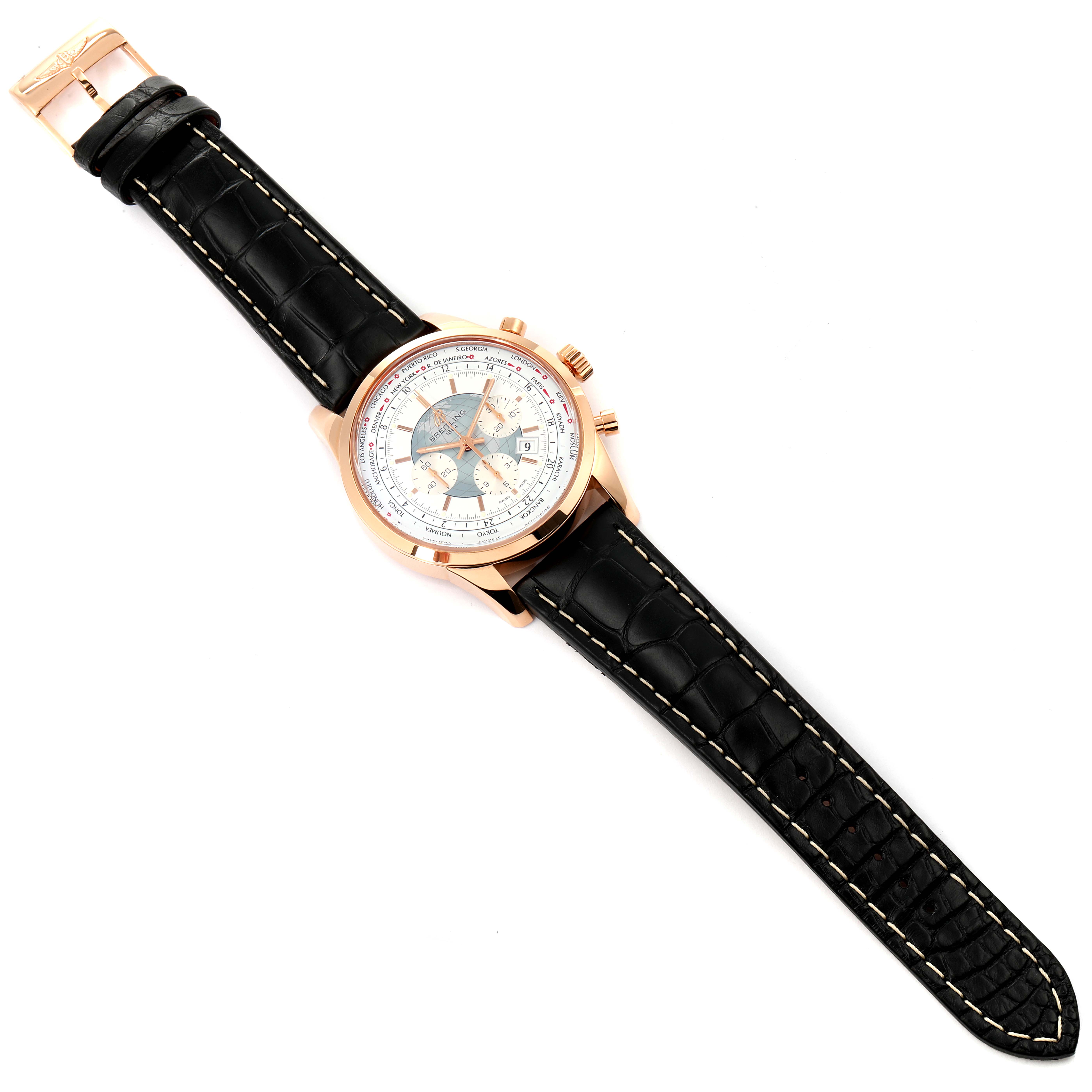 The Breitling Transocean RB0510U4-BB63BKLD Men's Rose Gold White Dial RB0510U4-BB63BKLD Men's Rose Gold White Dial watch is shown from a top-down angle, displaying the face, case, and black leather strap.