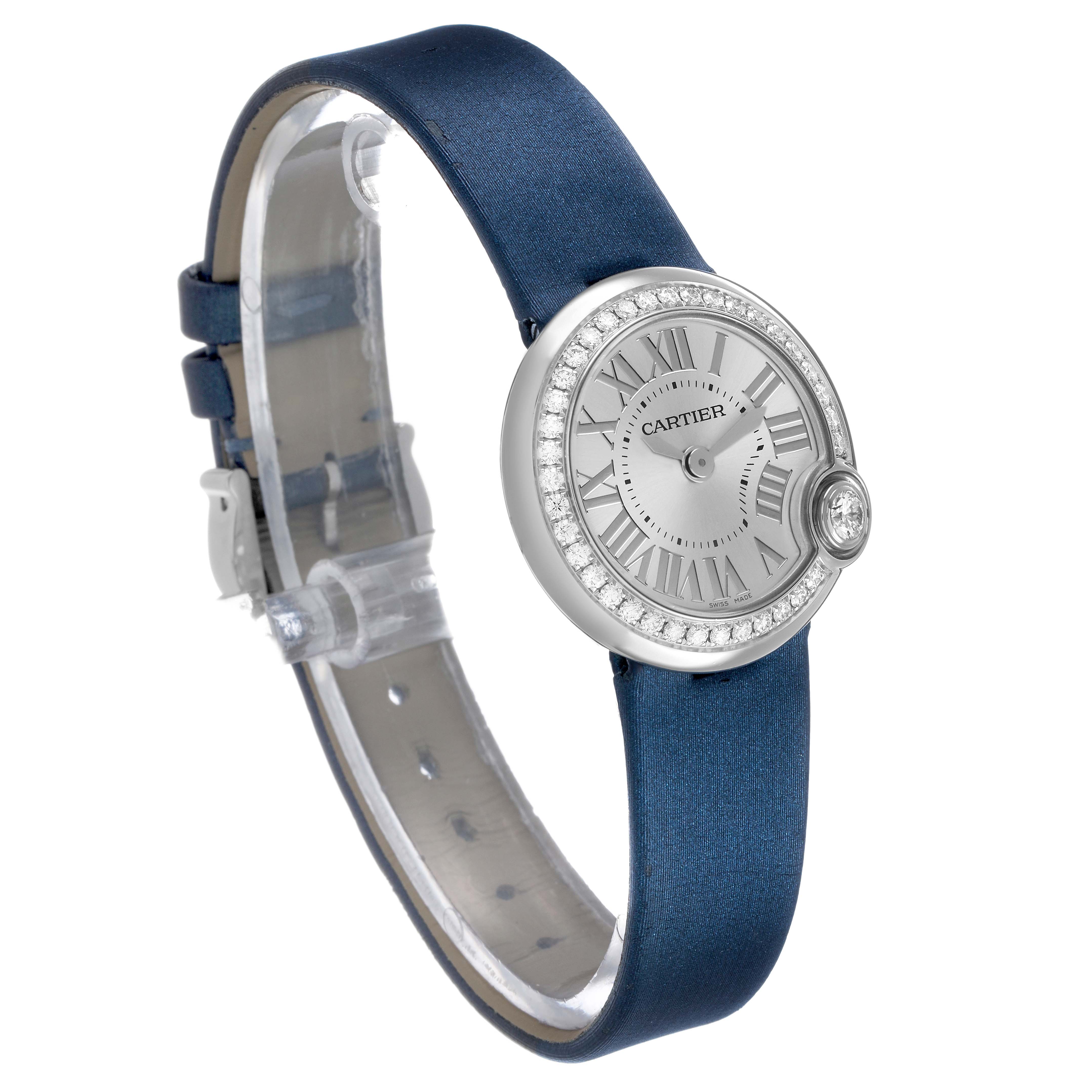 The Cartier Ballon Blanc W4BL0002 Women's Stainless Steel Silver Dial watch is shown from a front angle, highlighting its round dial, diamond bezel, and blue strap.