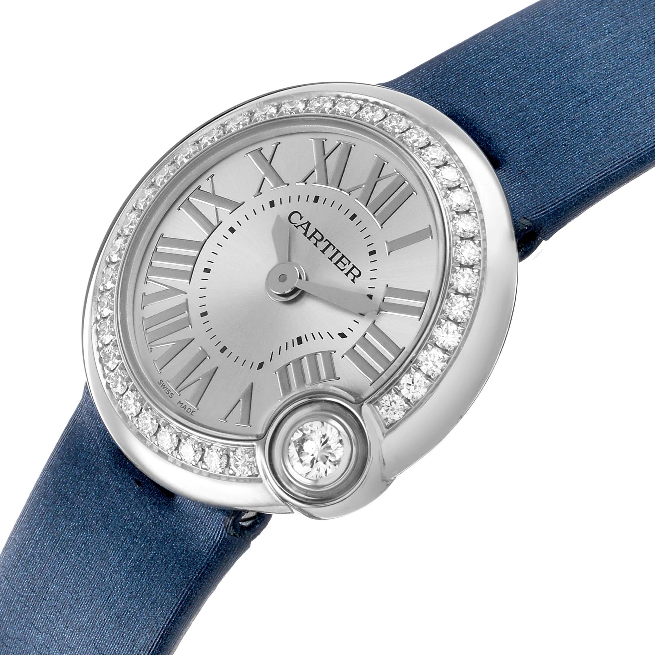 The Cartier Ballon Blanc W4BL0002 Women's Stainless Steel Silver Dial watch is shown from a front angle, highlighting the silver dial, diamond bezel, and blue strap.