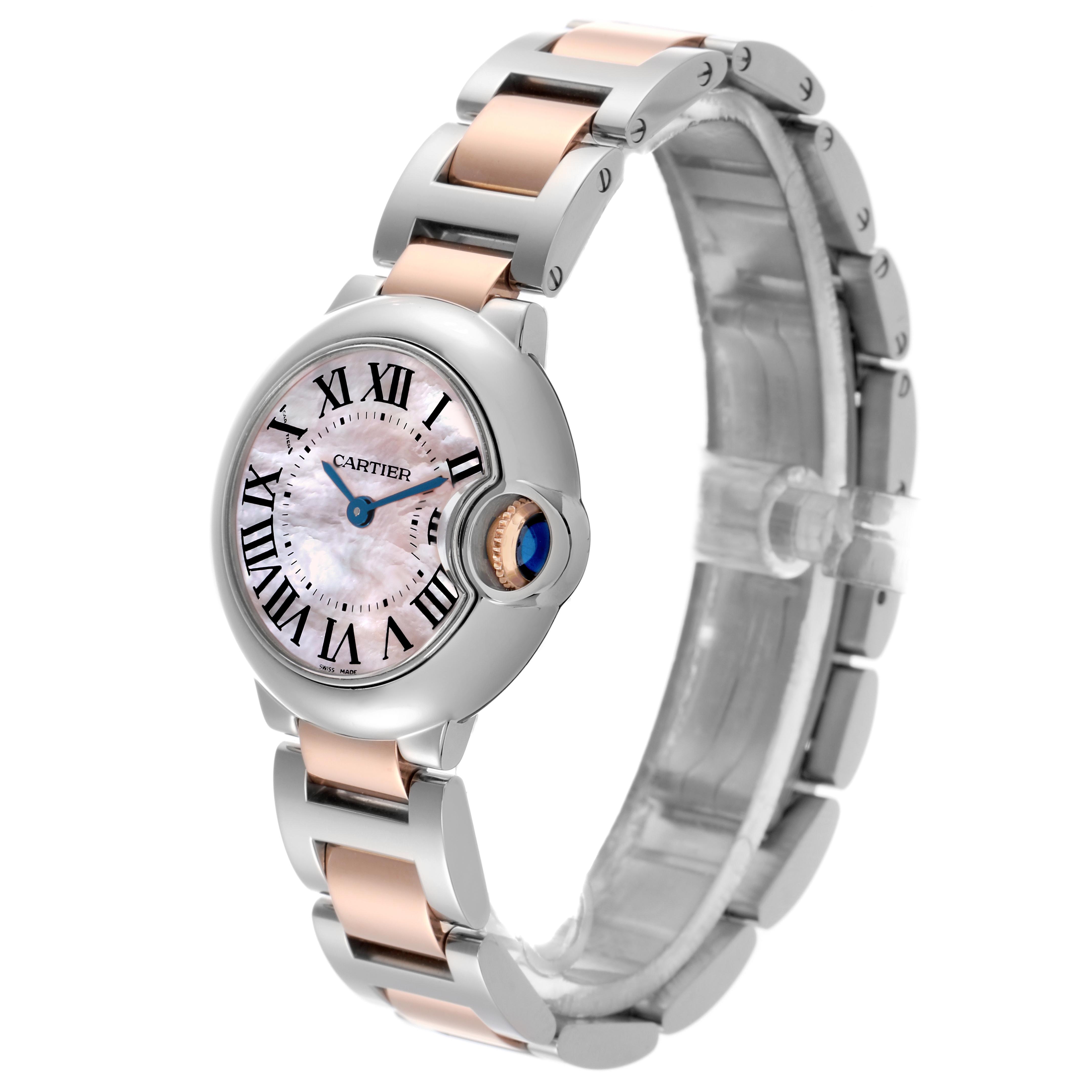 The Cartier Ballon Bleu W6920034 Women's Steel and Gold (two tone) Mother of Pearl Dial W6920034 Women's Steel and Gold (two tone) Mother of Pearl Dial watch is shown at an angle highlighting the face, crown, and two-tone bracelet.