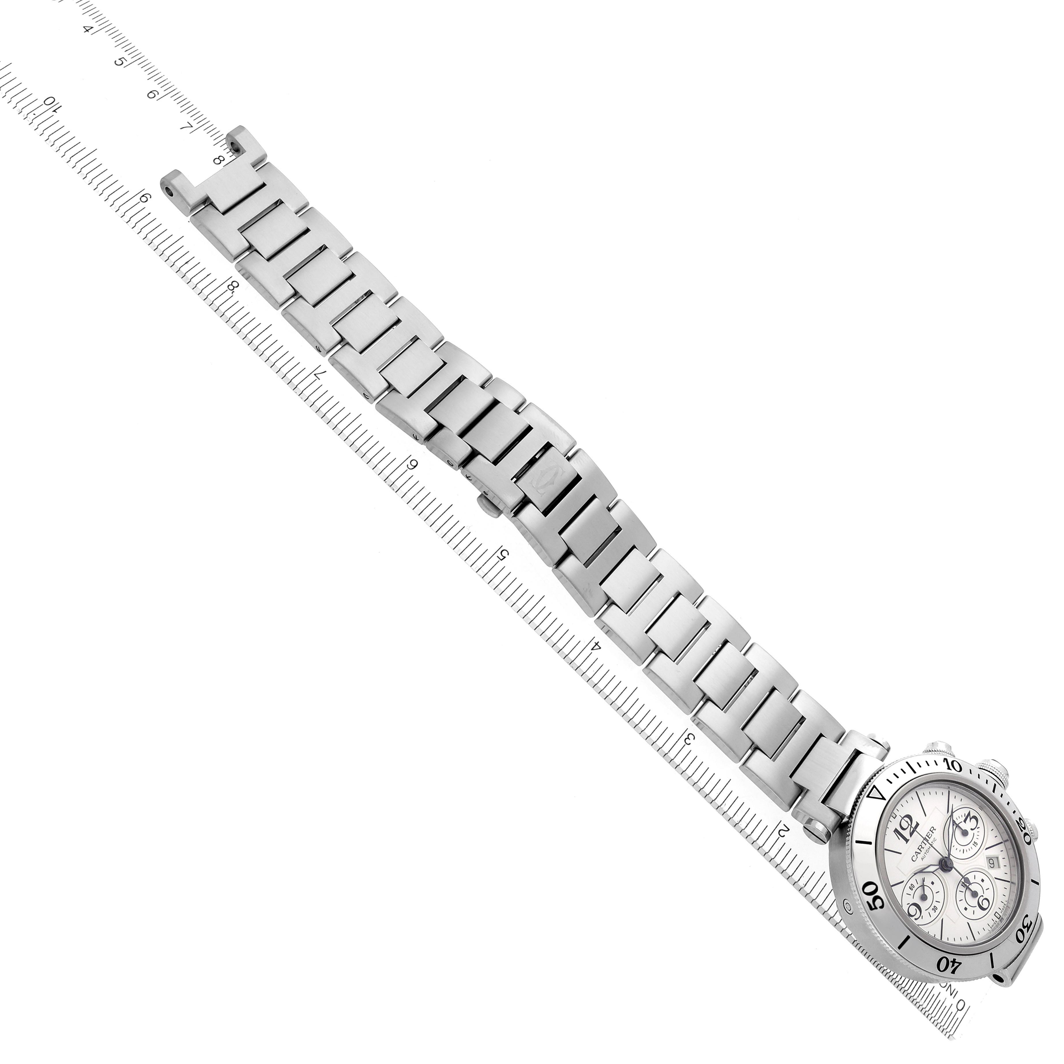 The Cartier Pasha W31089M7 Men's Stainless Steel Silver Dial W31089M7 Men's Stainless Steel Silver Dial watch is shown at an angle, highlighting the bracelet, face, and bezel, with a ruler for scale.