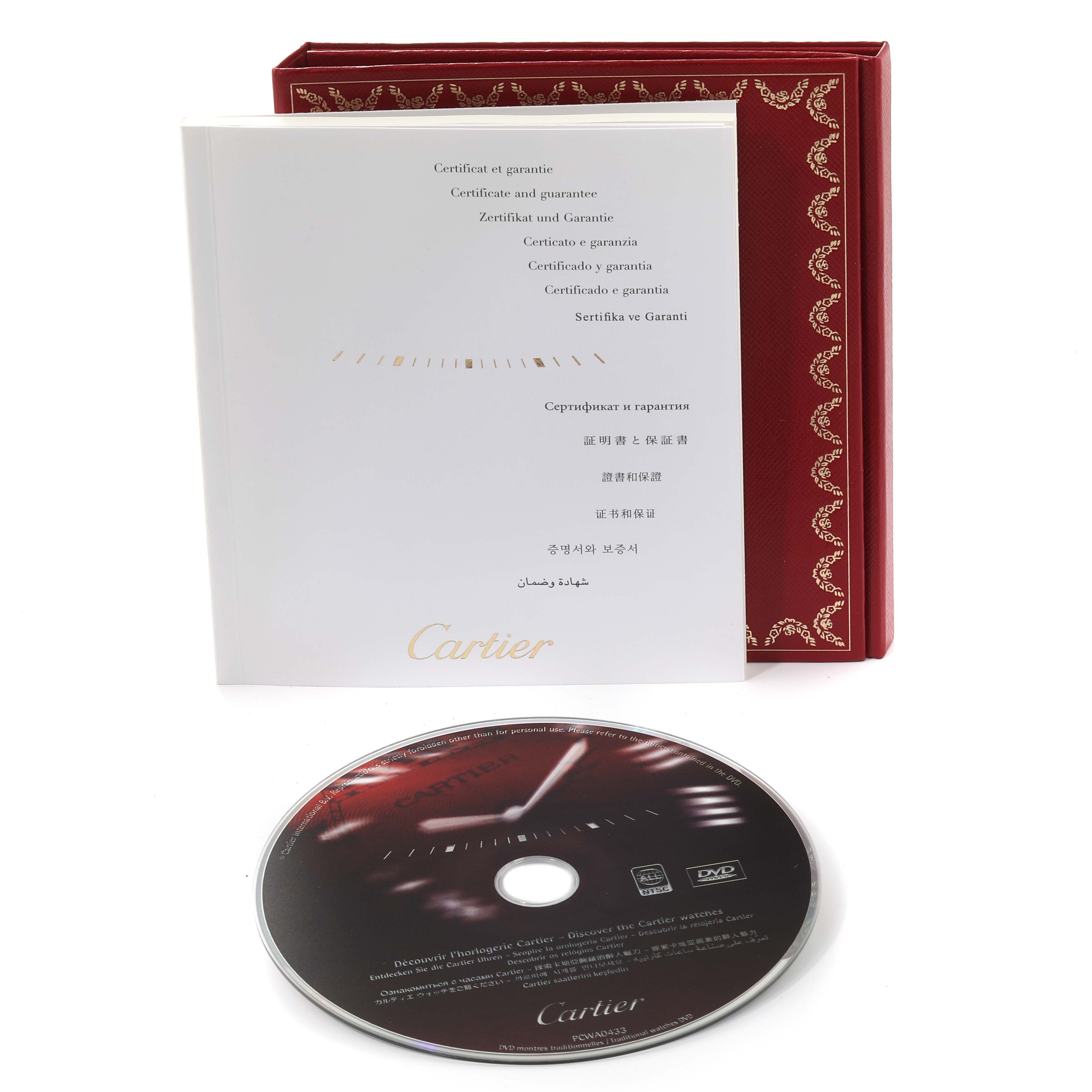 This image shows the warranty booklet, red box, and a DVD for the Cartier Ronde W6701005 Men
s Stainless Steel Silver Dial W6701005 Men
s Stainless Steel Silver Dial model watch.