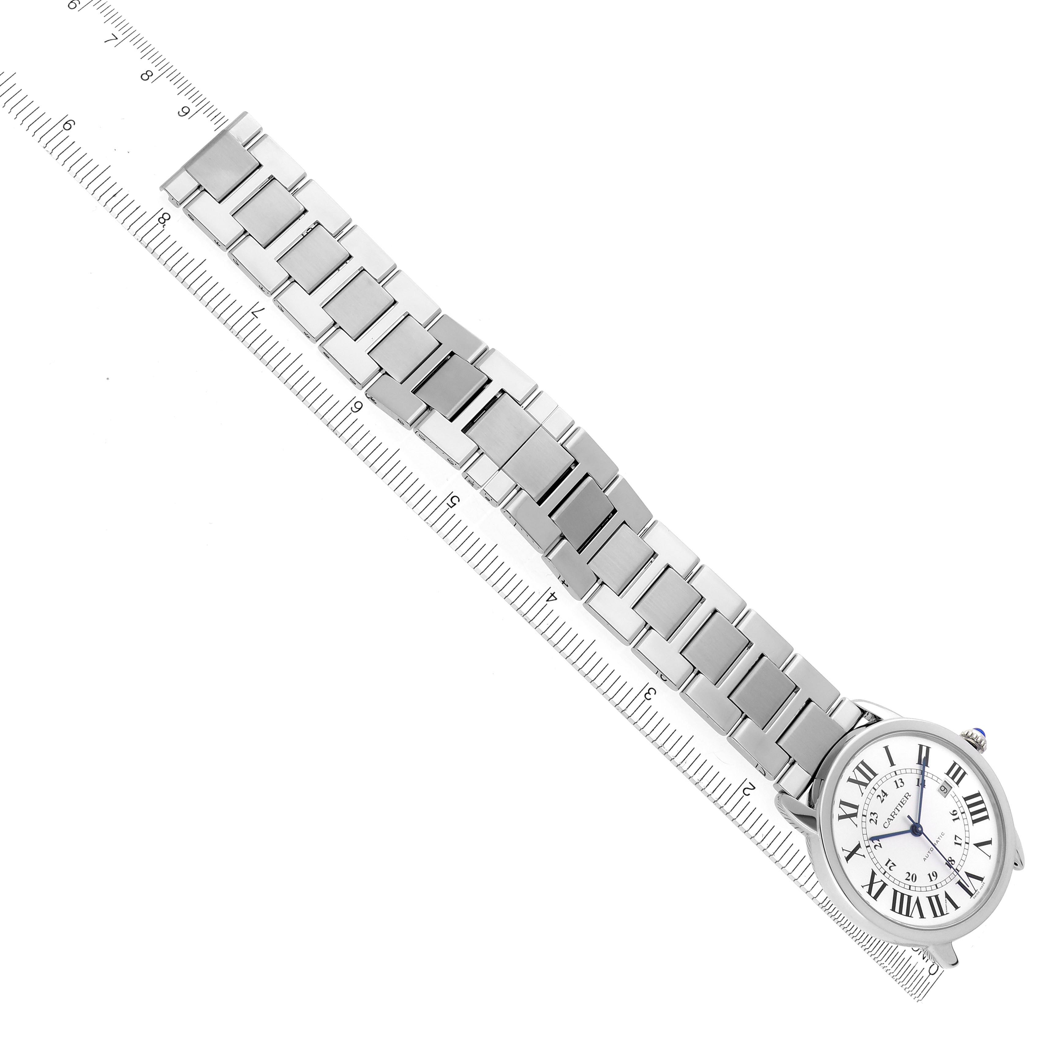 The Cartier Ronde W6701011 Men
s Stainless Steel Silver Dial W6701011 Men
s Stainless Steel Silver Dial watch is shown at an angle, highlighting its face and metal bracelet, aligned with a ruler for scale.