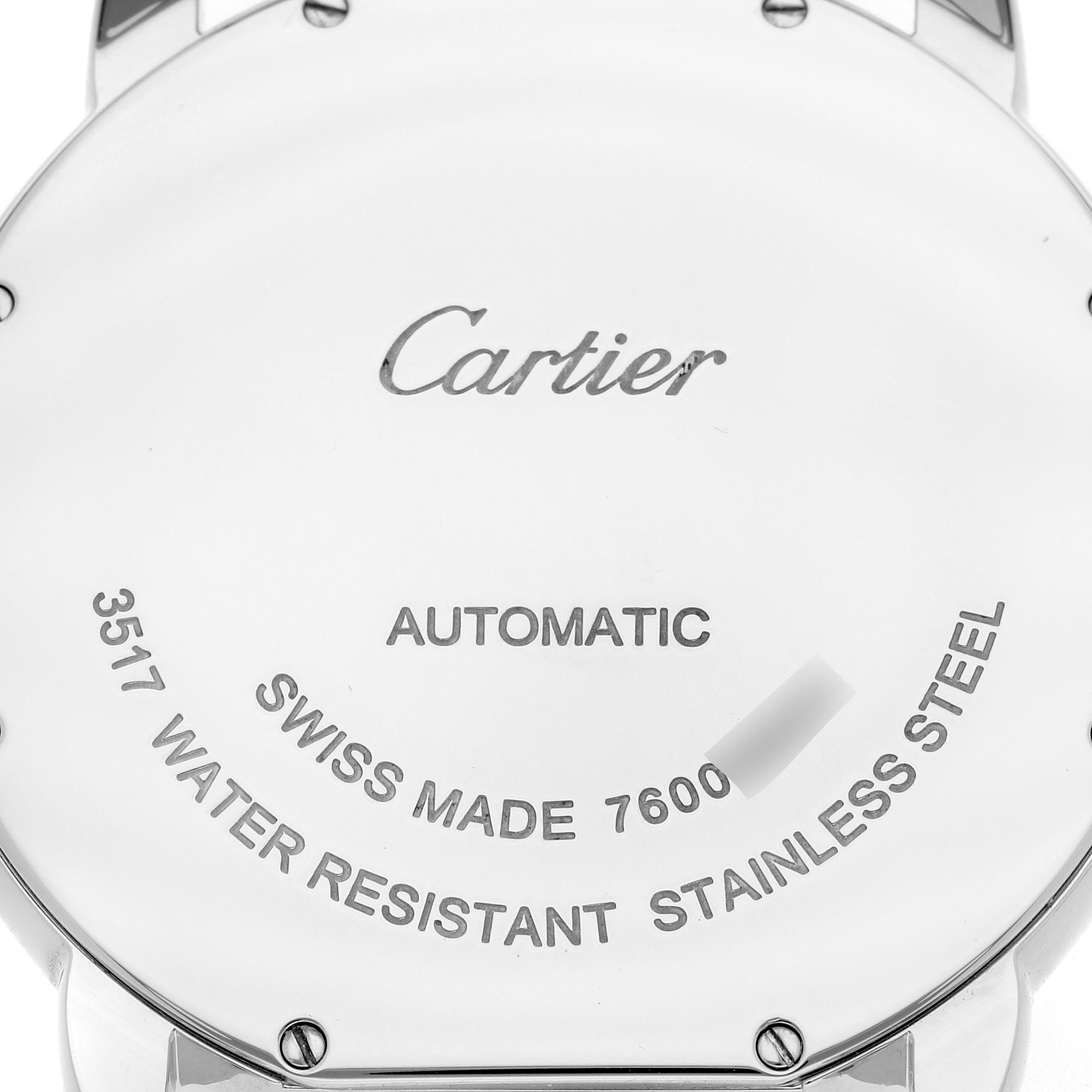 The image shows the back case of a Cartier Ronde W6701011 Men
s Stainless Steel Silver Dial W6701011 Men
s Stainless Steel Silver Dial watch, displaying engravings and screws.
