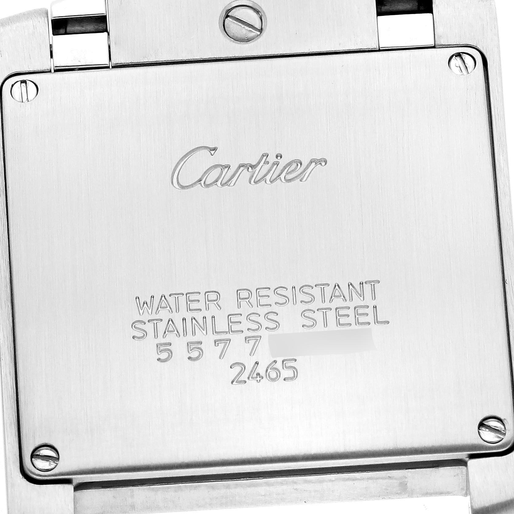 The image shows the back case of a Cartier Tank Française watch, highlighting engraved details and screws.