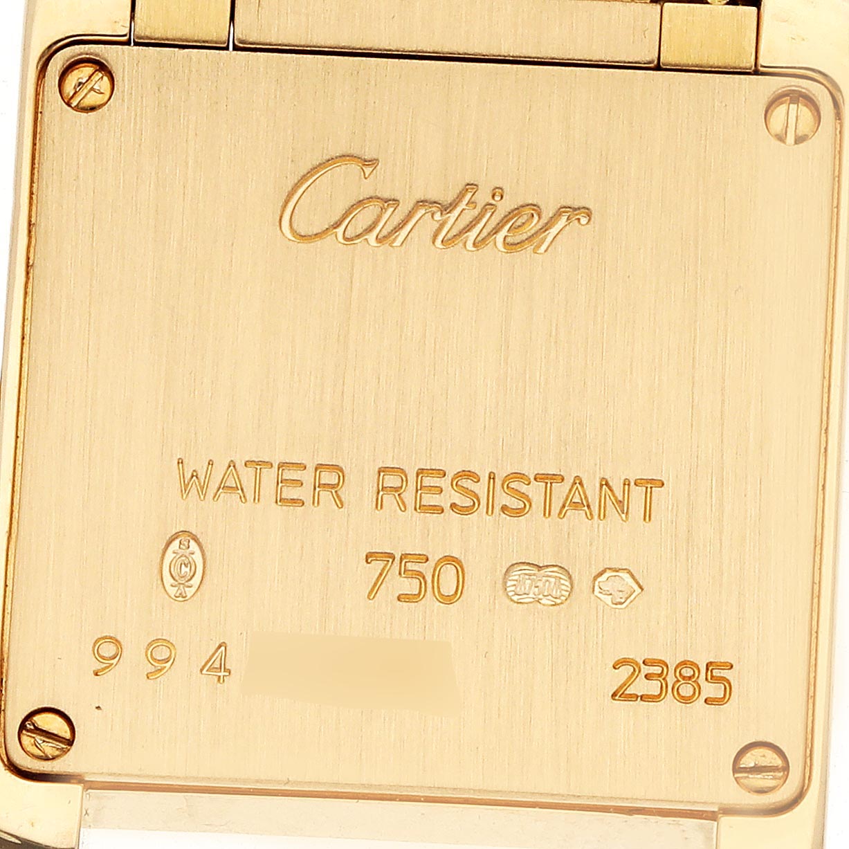 The image shows the back of a Cartier Tank Française watch, highlighting engravings and screws.