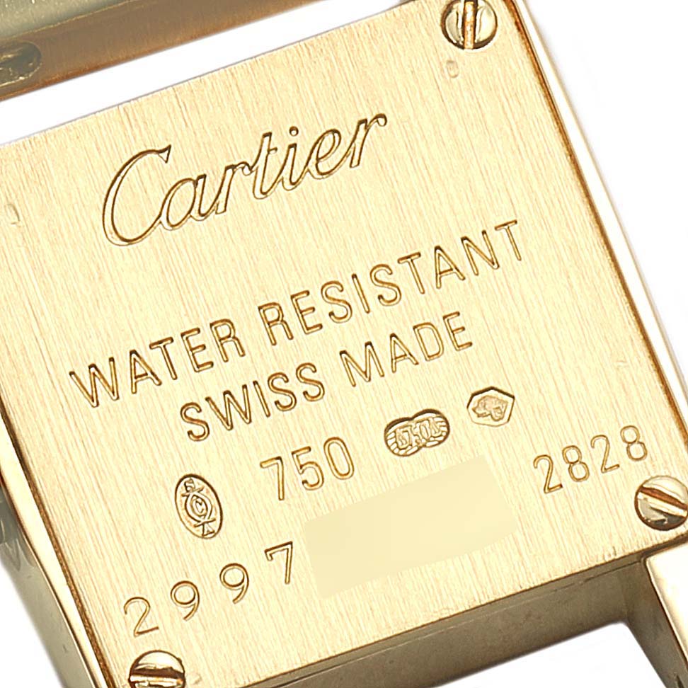 The angle shows the back of the Cartier Tankissime W650048H Women's Yellow Gold Silver Dial W650048H Women's Yellow Gold Silver Dial watch, highlighting markings, engravings, and screws.