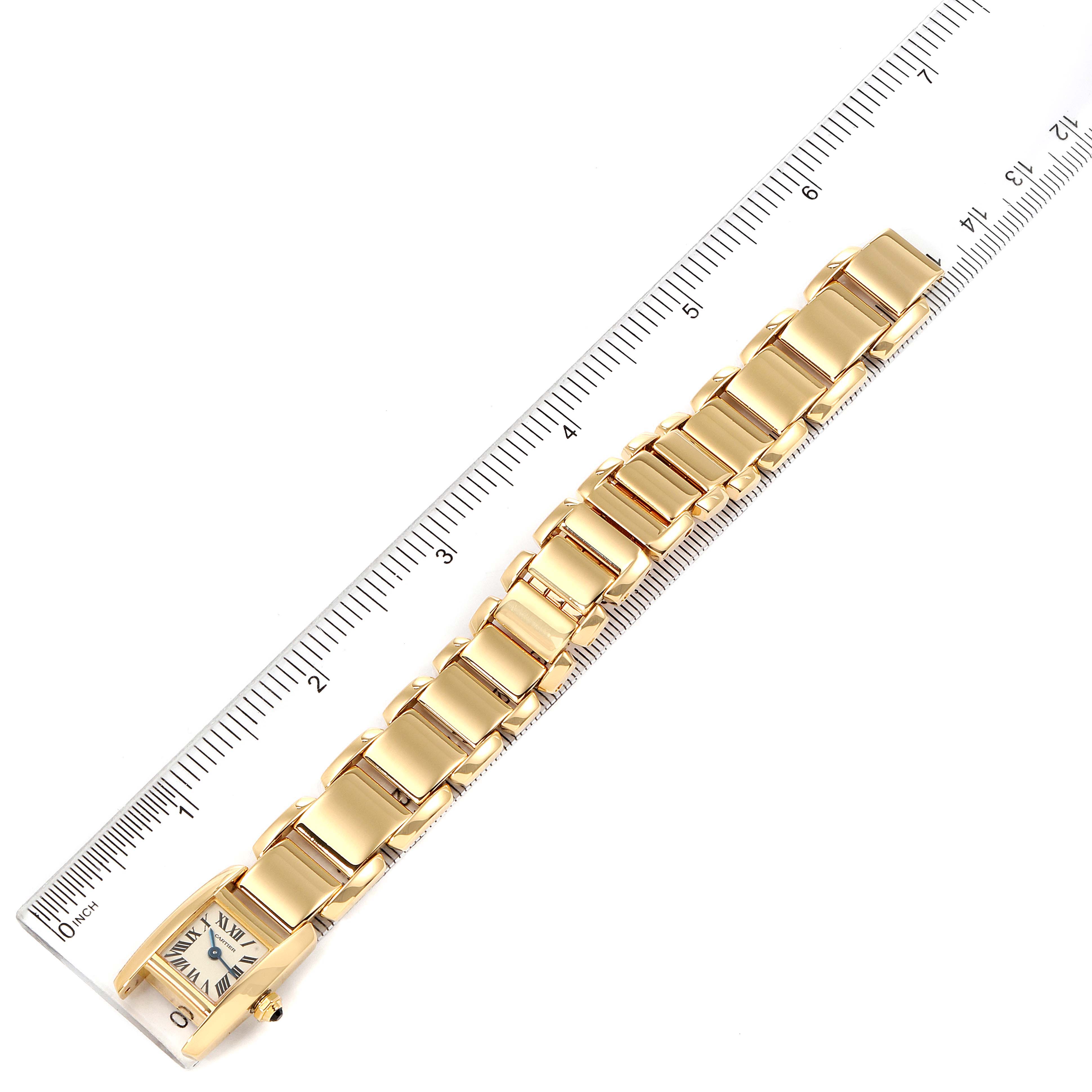 The image shows a Cartier Tankissime W650048H Women's Yellow Gold Silver Dial W650048H Women's Yellow Gold Silver Dial watch laid flat next to a ruler, highlighting the watch face and the entire bracelet.