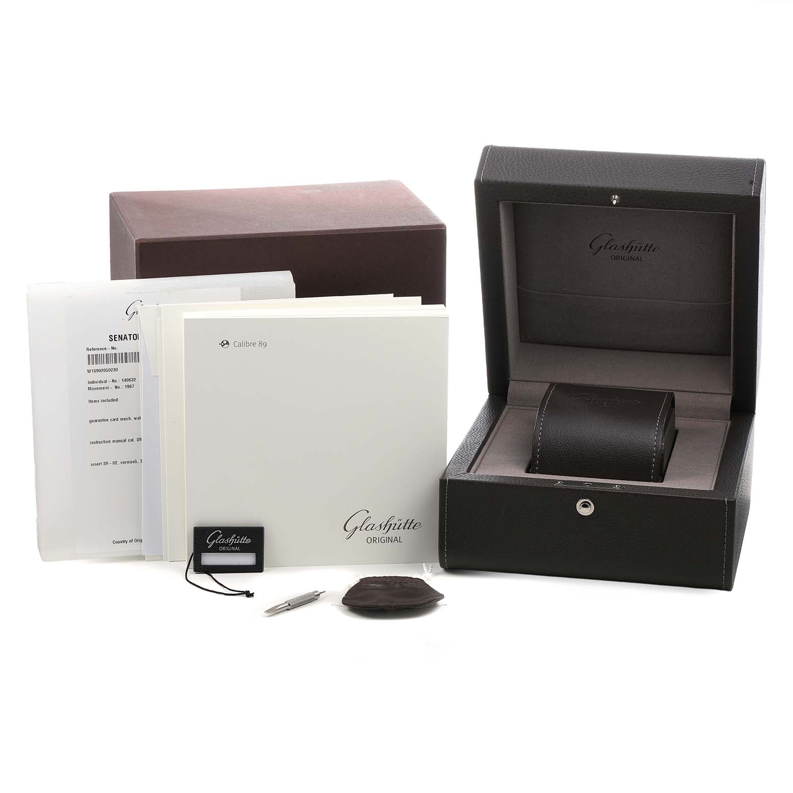 The image shows the Glashütte Original watch box, manual, warranty card, and accessories from a front angle.