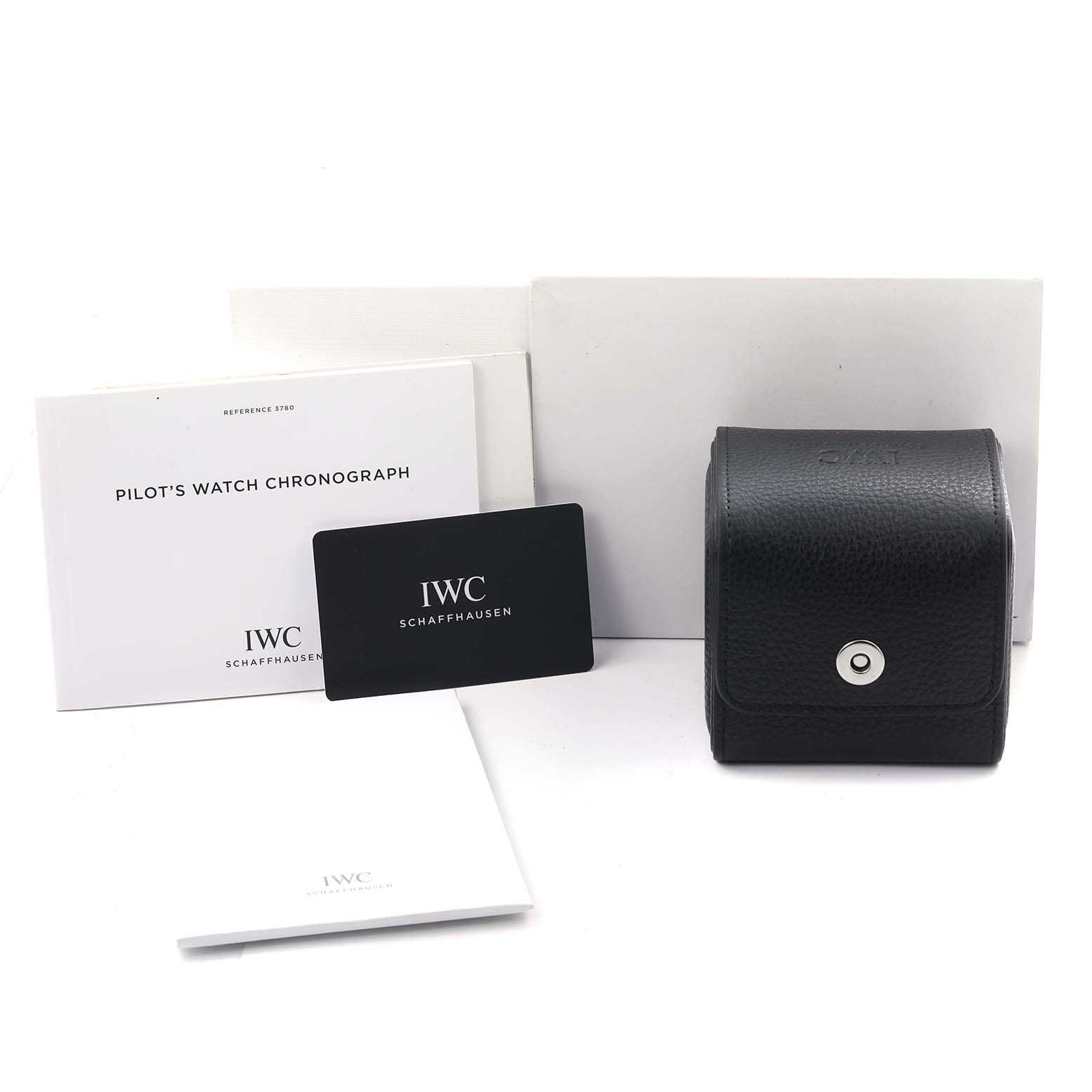 The image features IWC Pilot IW378004 Men's Stainless Steel Blue Dial IW378004 Men's Stainless Steel Blue Dial watch accessories, including a black case, warranty card, and instruction booklets.