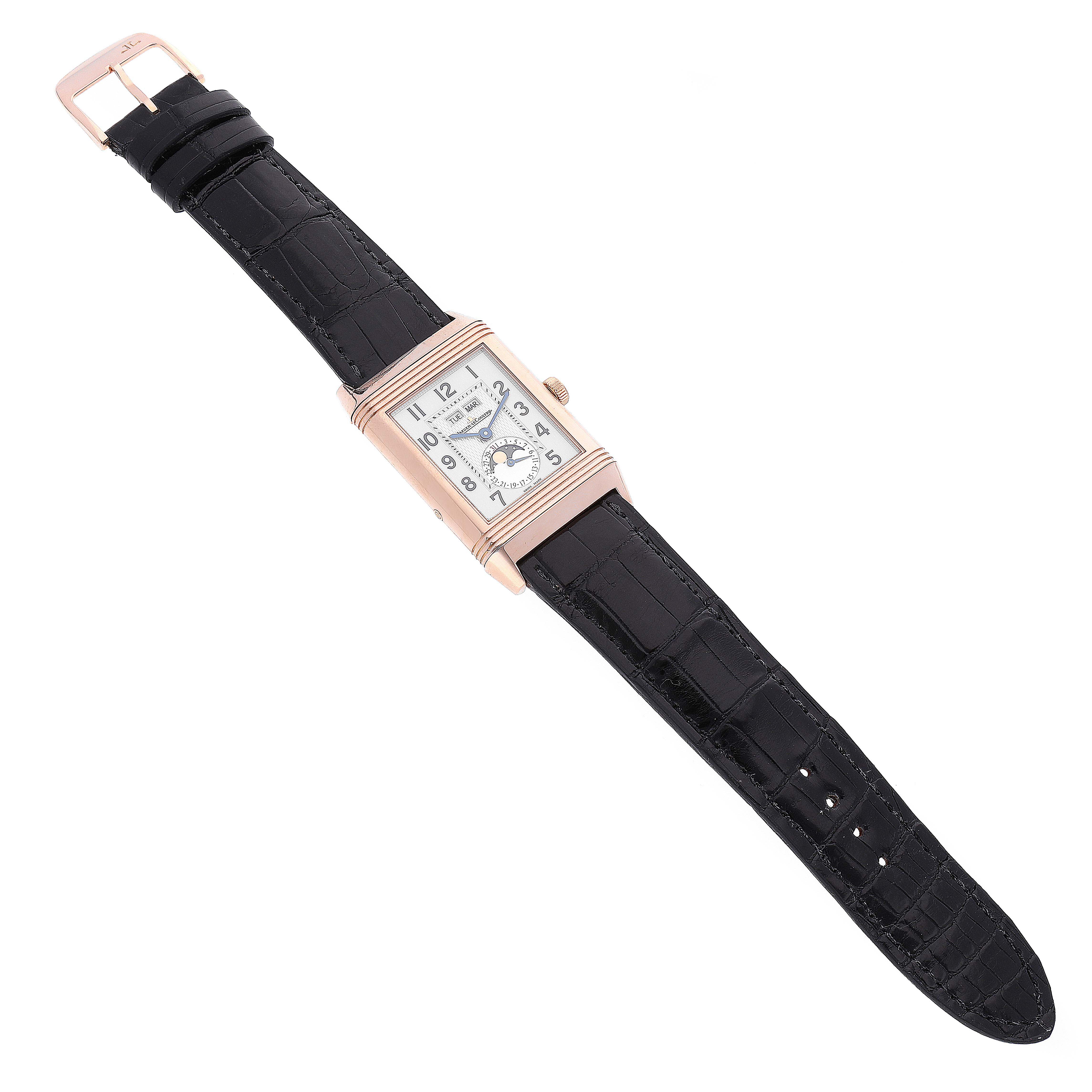 The image shows a Jaeger-LeCoultre Reverso watch laid flat, displaying the watch face and black leather strap at an angled top view.