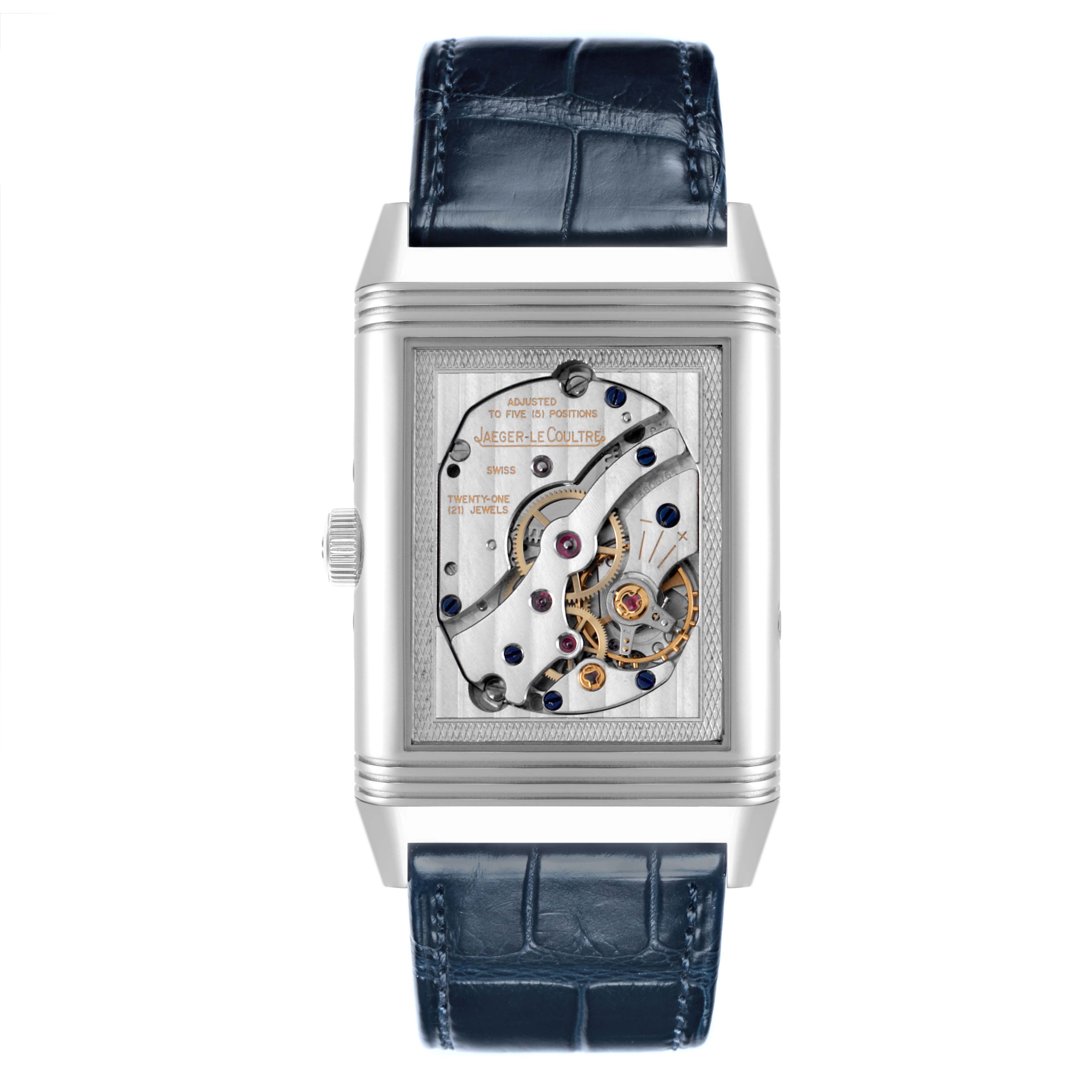 The image shows a Jaeger-LeCoultre Reverso watch from the front, highlighting the open mechanical back with intricate movement details.