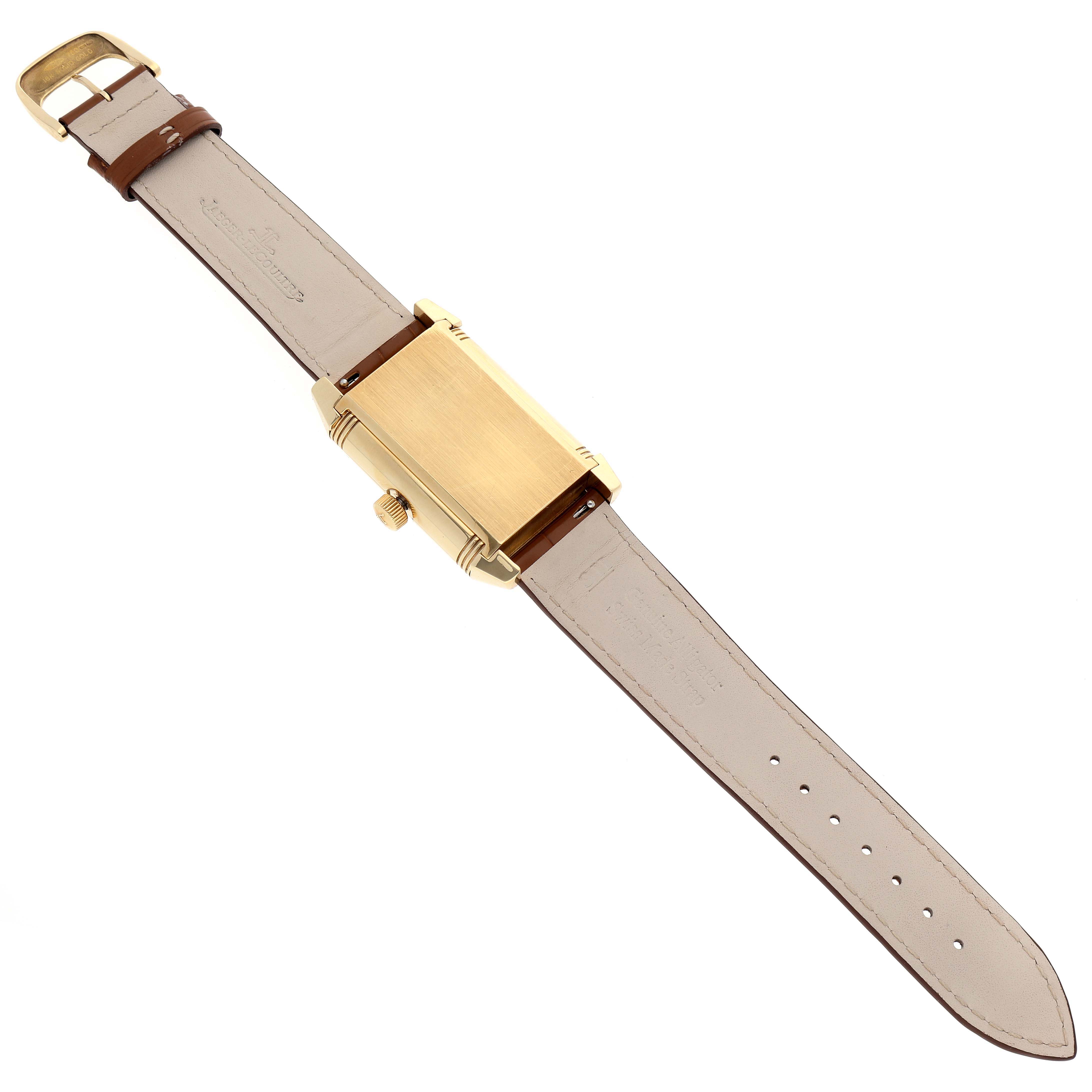 The image shows the backside of a Jaeger-LeCoultre Reverso watch, showcasing its leather strap and gold case.