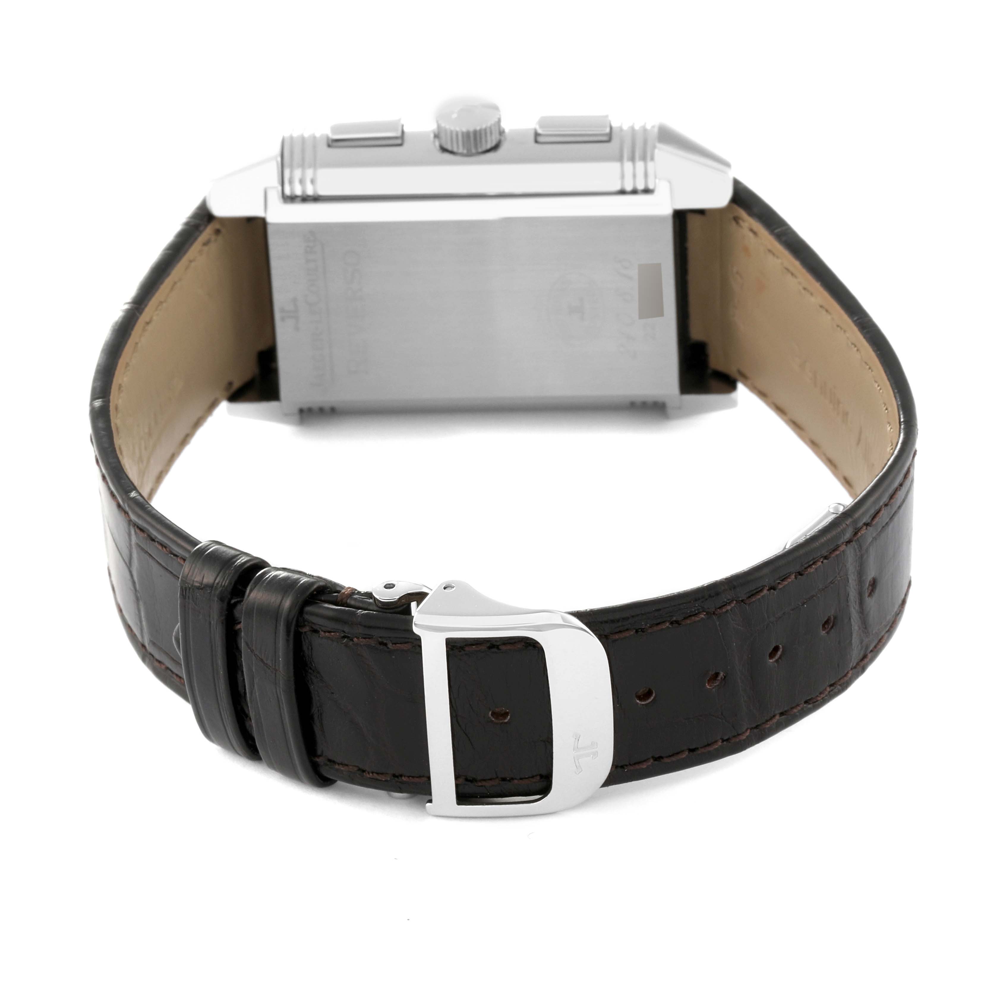 The image shows the back view of a Jaeger-LeCoultre Reverso watch, focusing on the case back, crown, and leather strap with buckle.