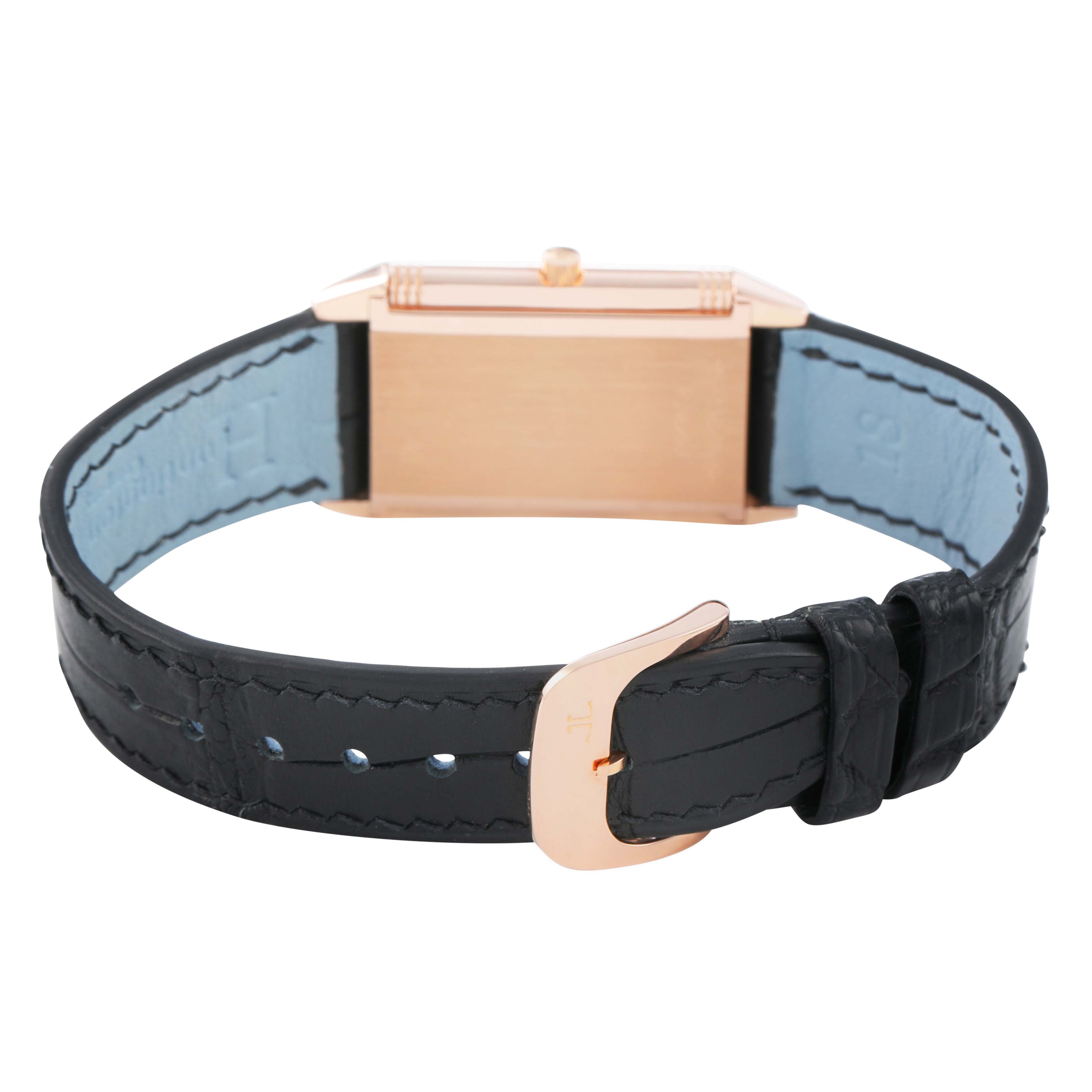 The image shows the back of a Jaeger-LeCoultre Reverso watch, highlighting the strap and clasp.