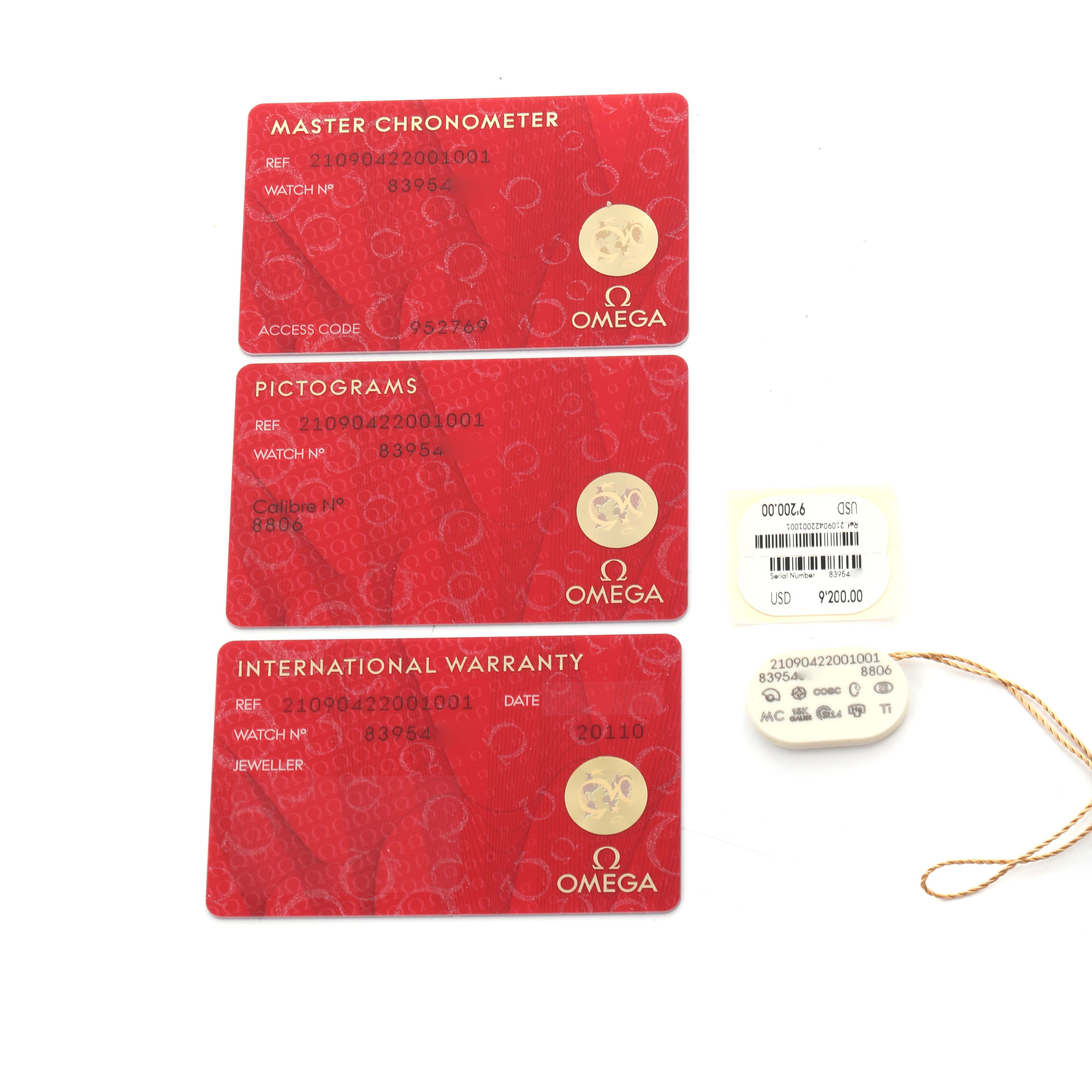 The image shows three Omega Seamaster 210.90.42.20.01.001 Men's Titanium Brown Dial 210.90.42.20.01.001 Men's Titanium Brown Dial cards (Master Chronometer, Pictograms, and International Warranty) and two tags.