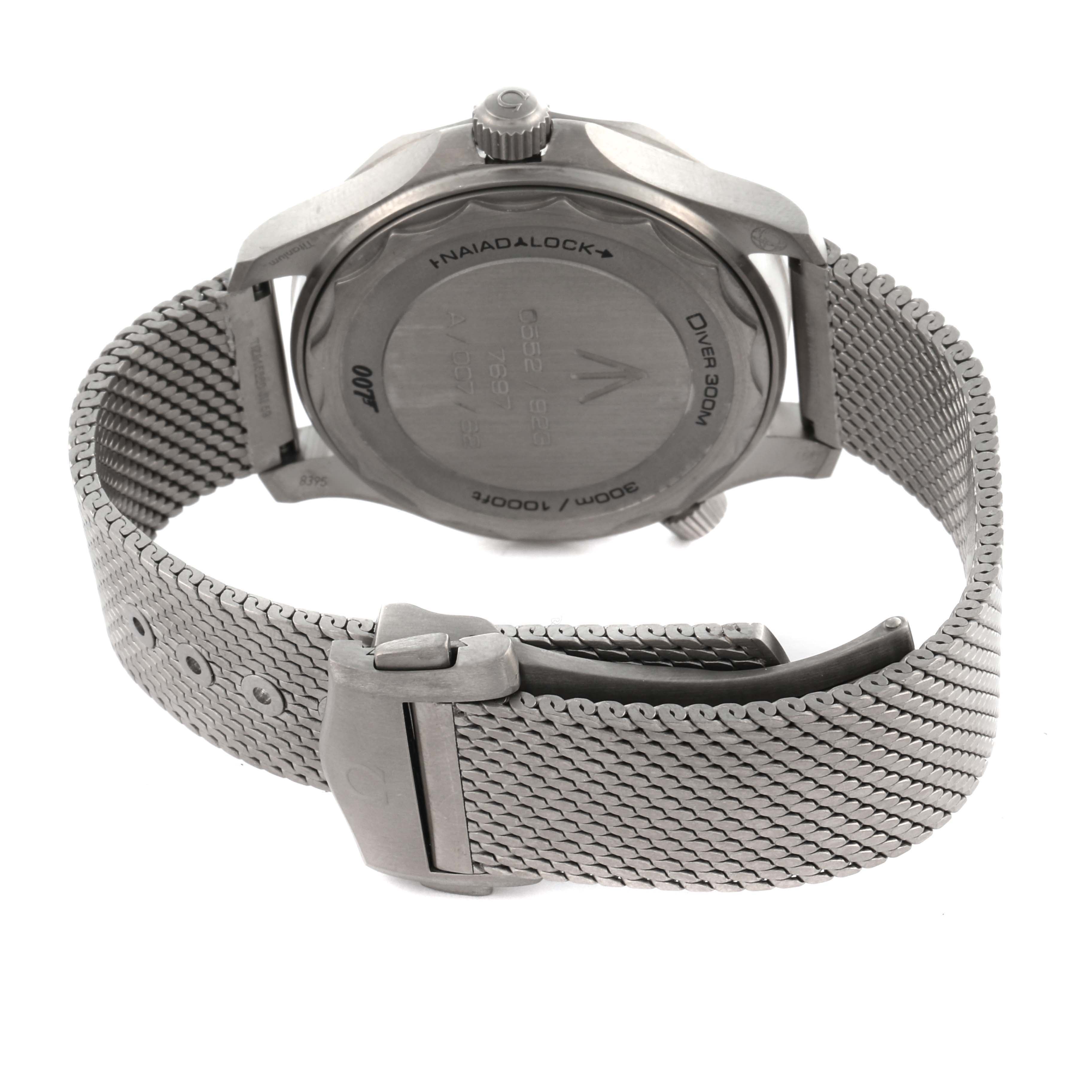 The Omega Seamaster 210.90.42.20.01.001 Men's Titanium Brown Dial 210.90.42.20.01.001 Men's Titanium Brown Dial watch is shown from the back, displaying its case back, mesh strap, and clasp.