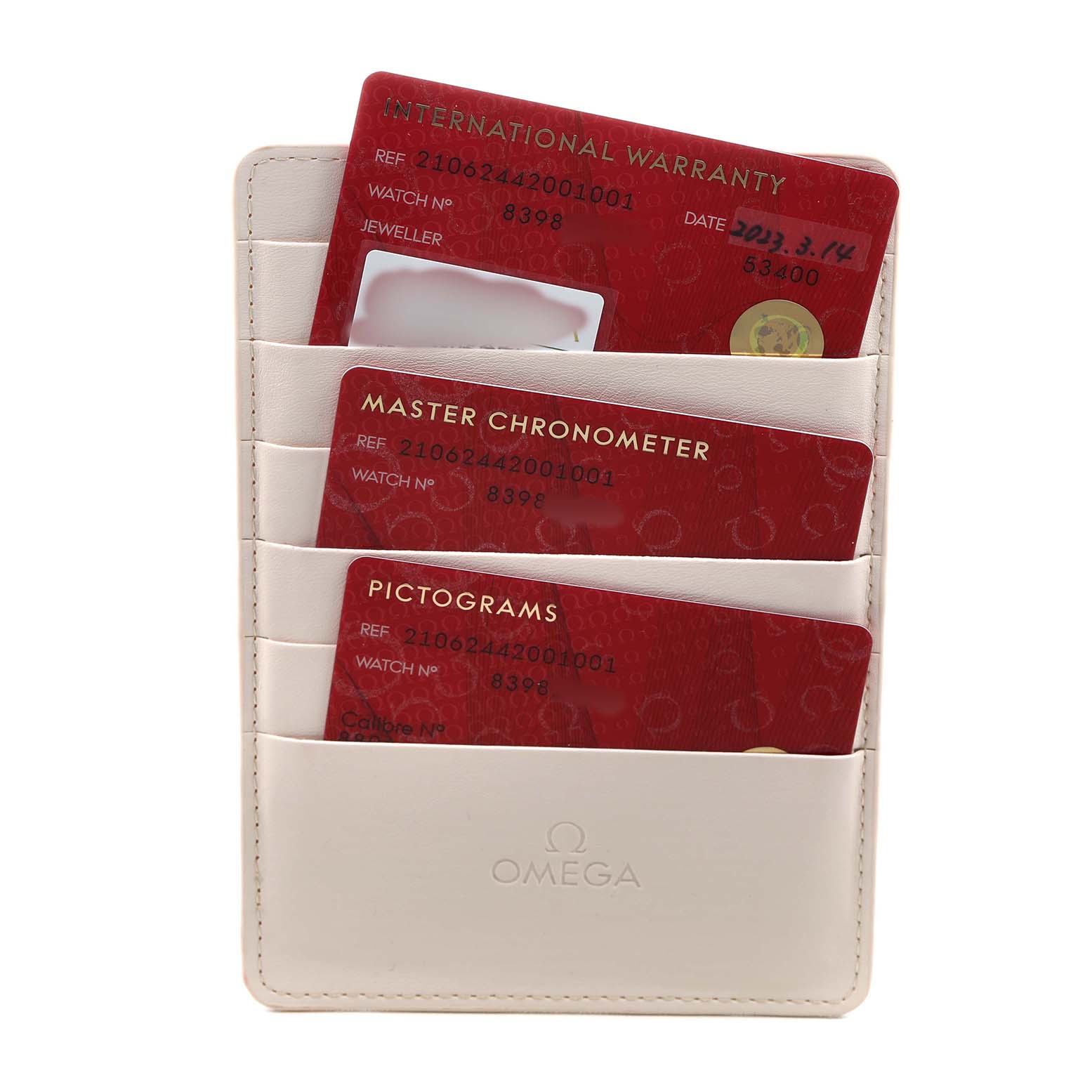 The image shows warranty and certification cards in a holder for the Omega Seamaster 210.62.44.20.01.001 Men's Ceramic Black Dial model.