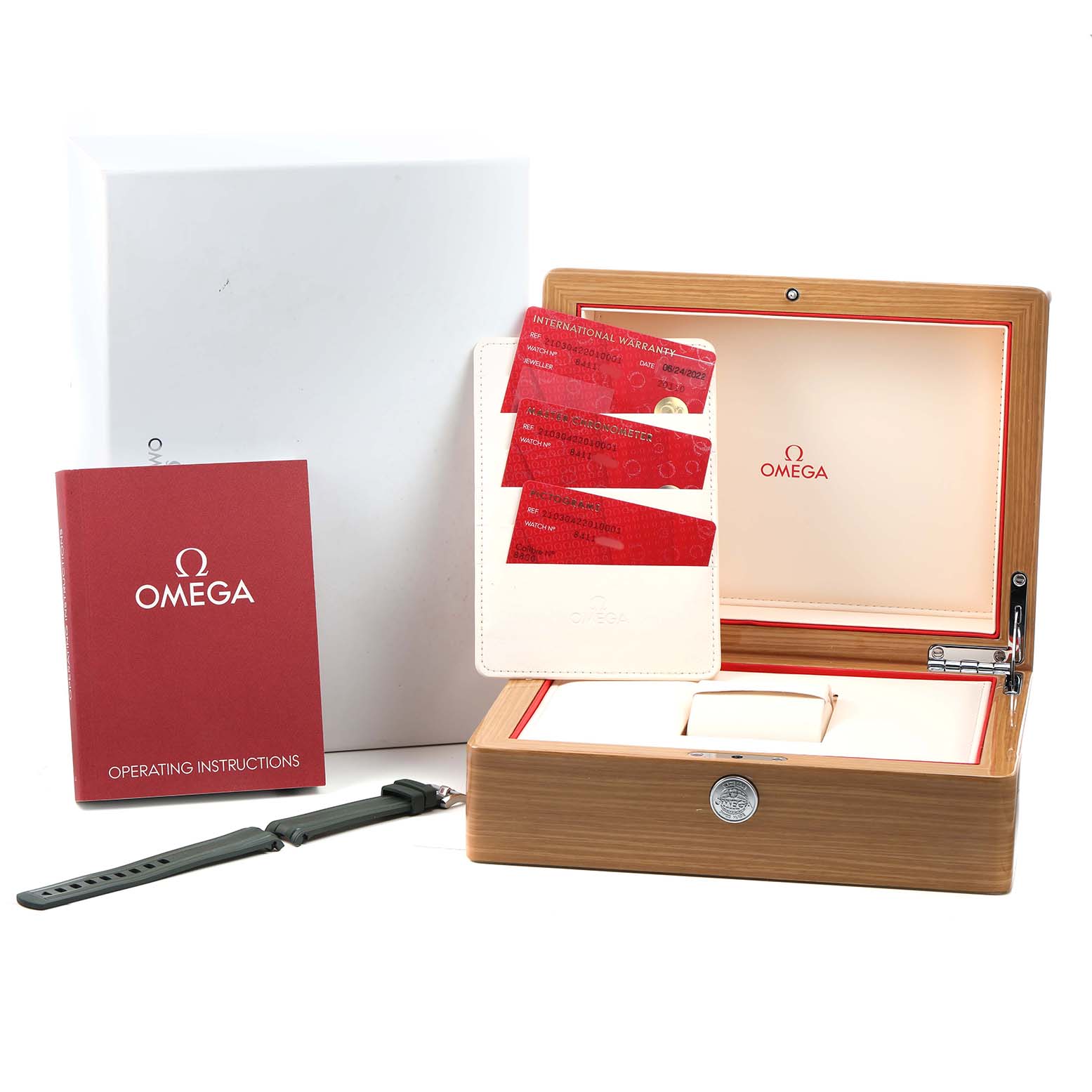 The image shows the packaging of an Omega Seamaster 210.30.42.20.10.001 Men's Stainless Steel Green Dial, including a wooden box, instruction manual, warranty cards, and an extra strap.