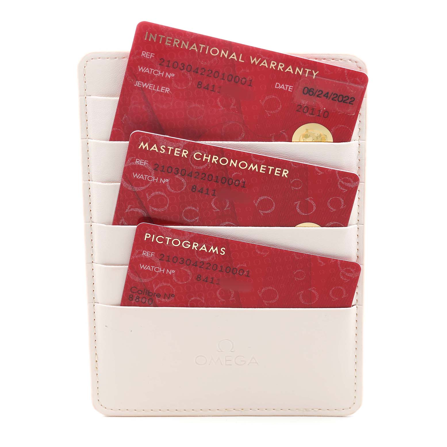 The image shows warranty and chronometer certification cards for the Omega Seamaster 210.30.42.20.10.001 Men's Stainless Steel Green Dial, displayed in a beige cardholder.